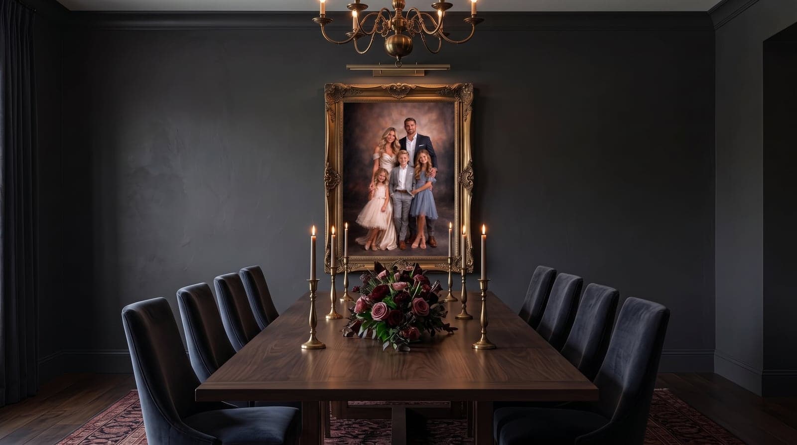 Gold-framed family portrait hung under a brass chandelier in a dark formal dining room