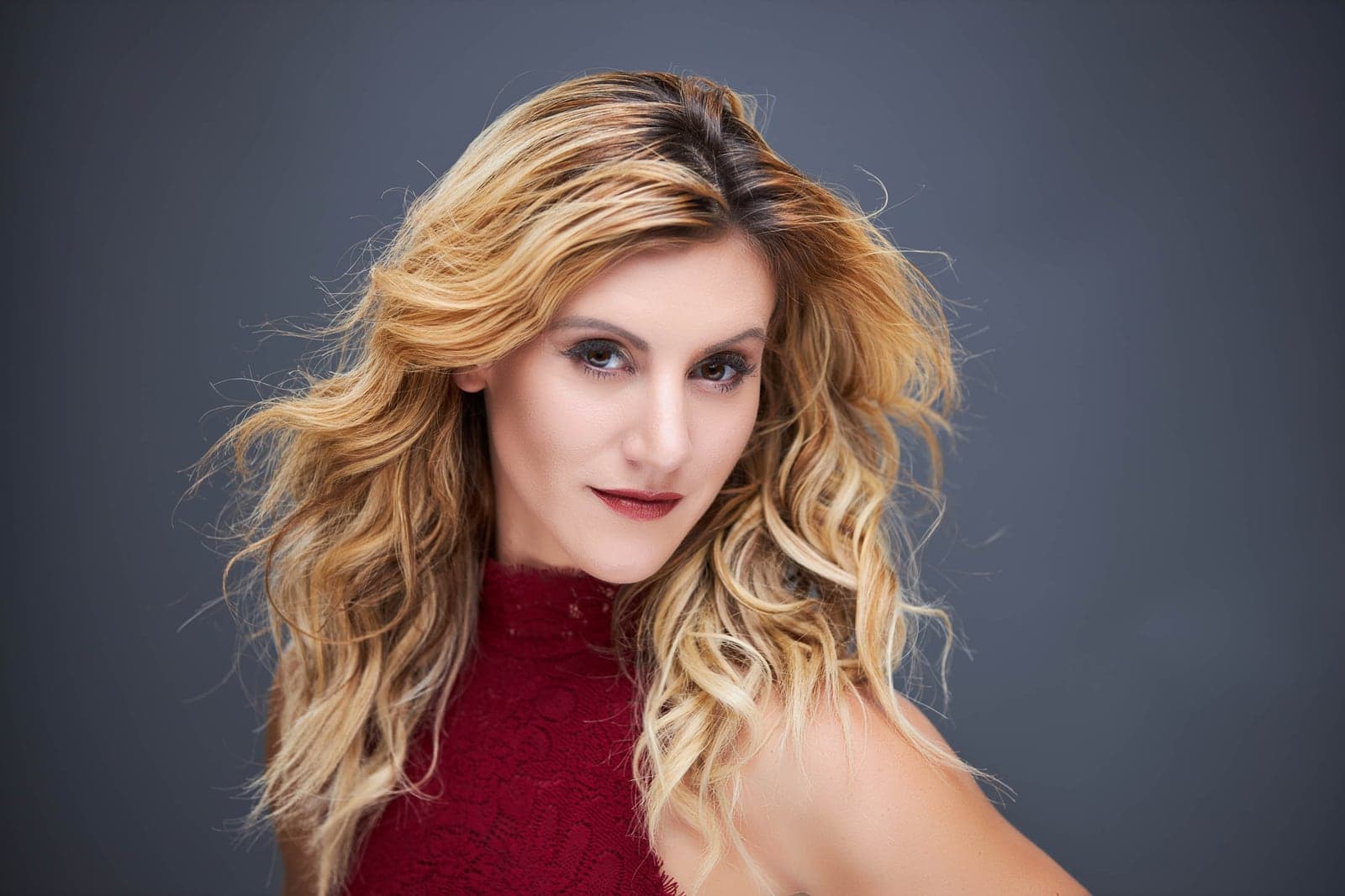 Branding headshot of a blonde woman on a grey background