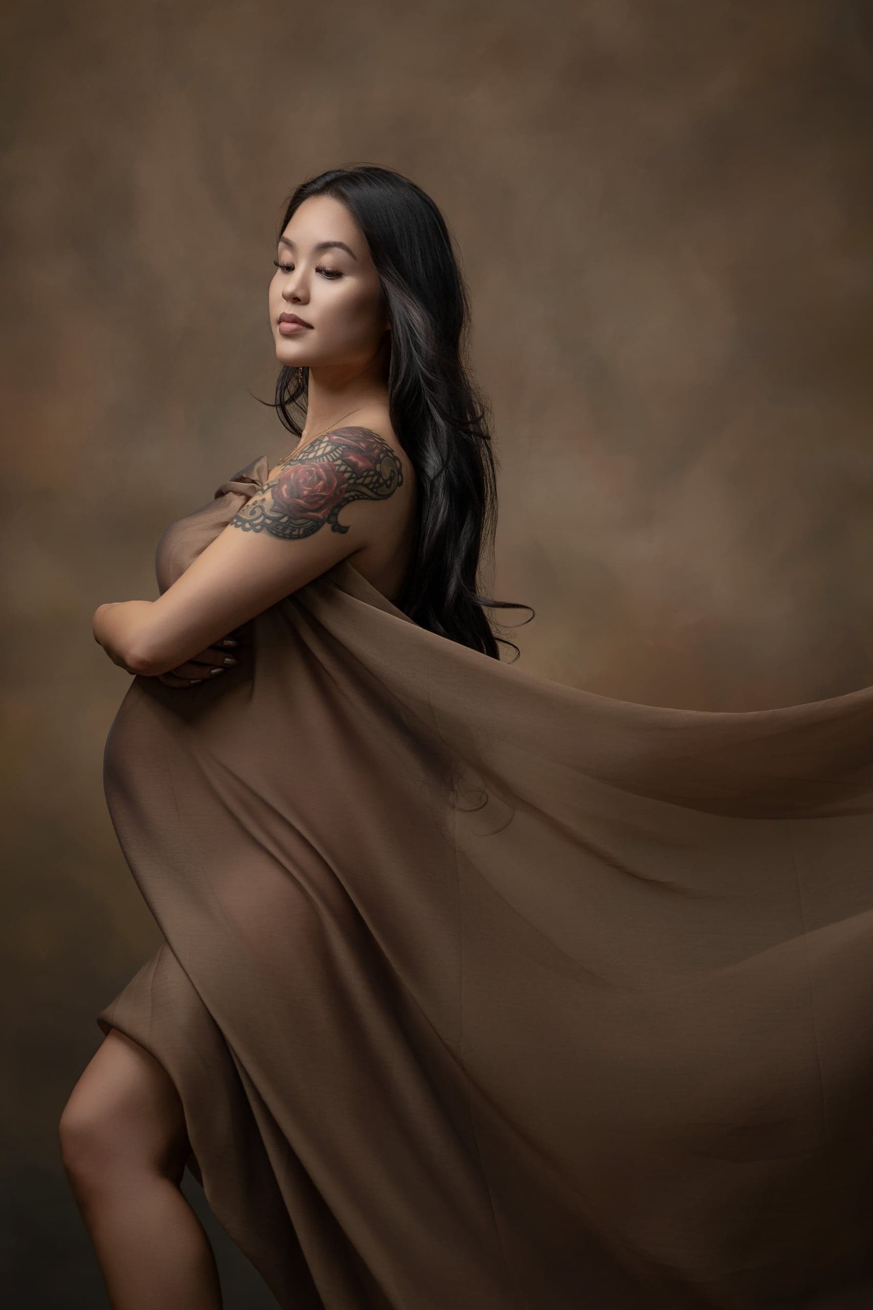 Maternity portrait in a flowing taupe gown
