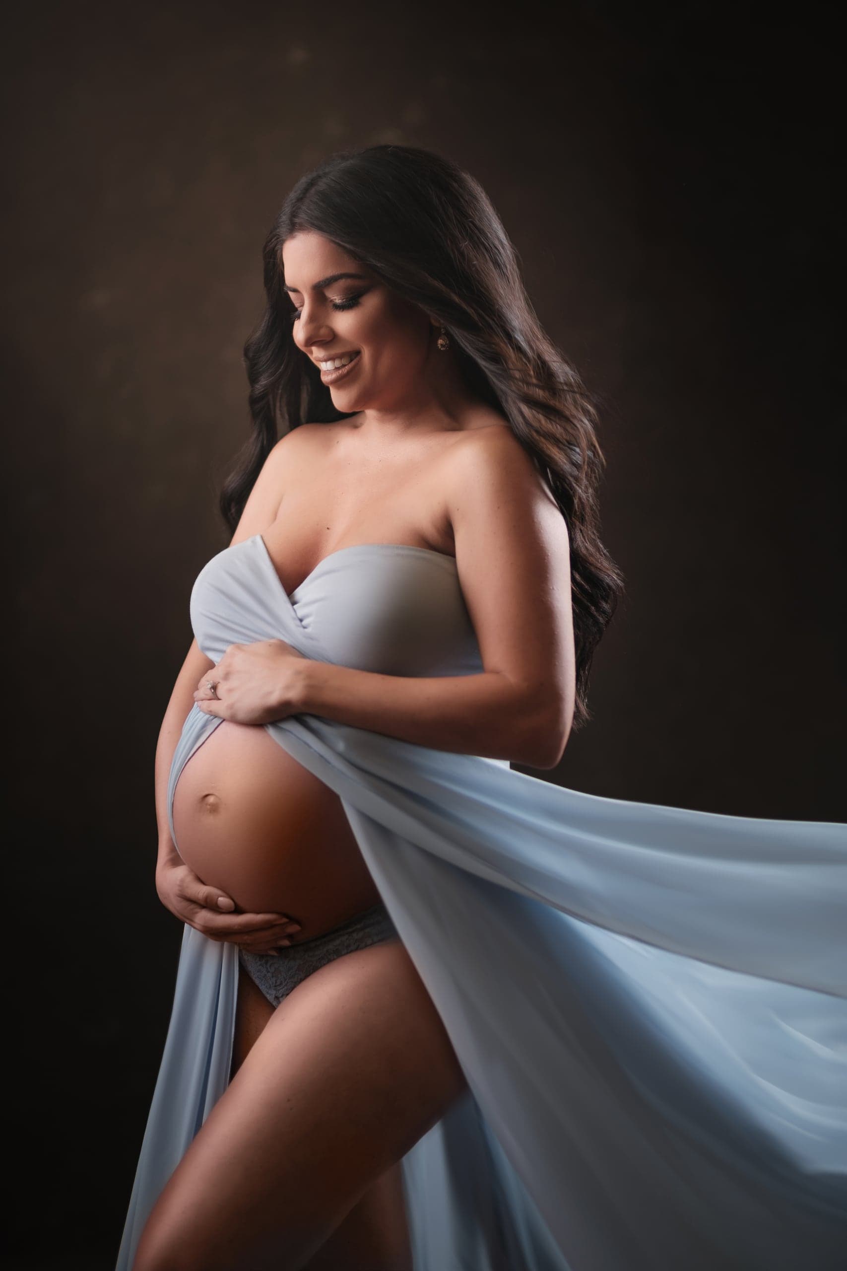 Maternity portrait in a strapless powder-blue gown