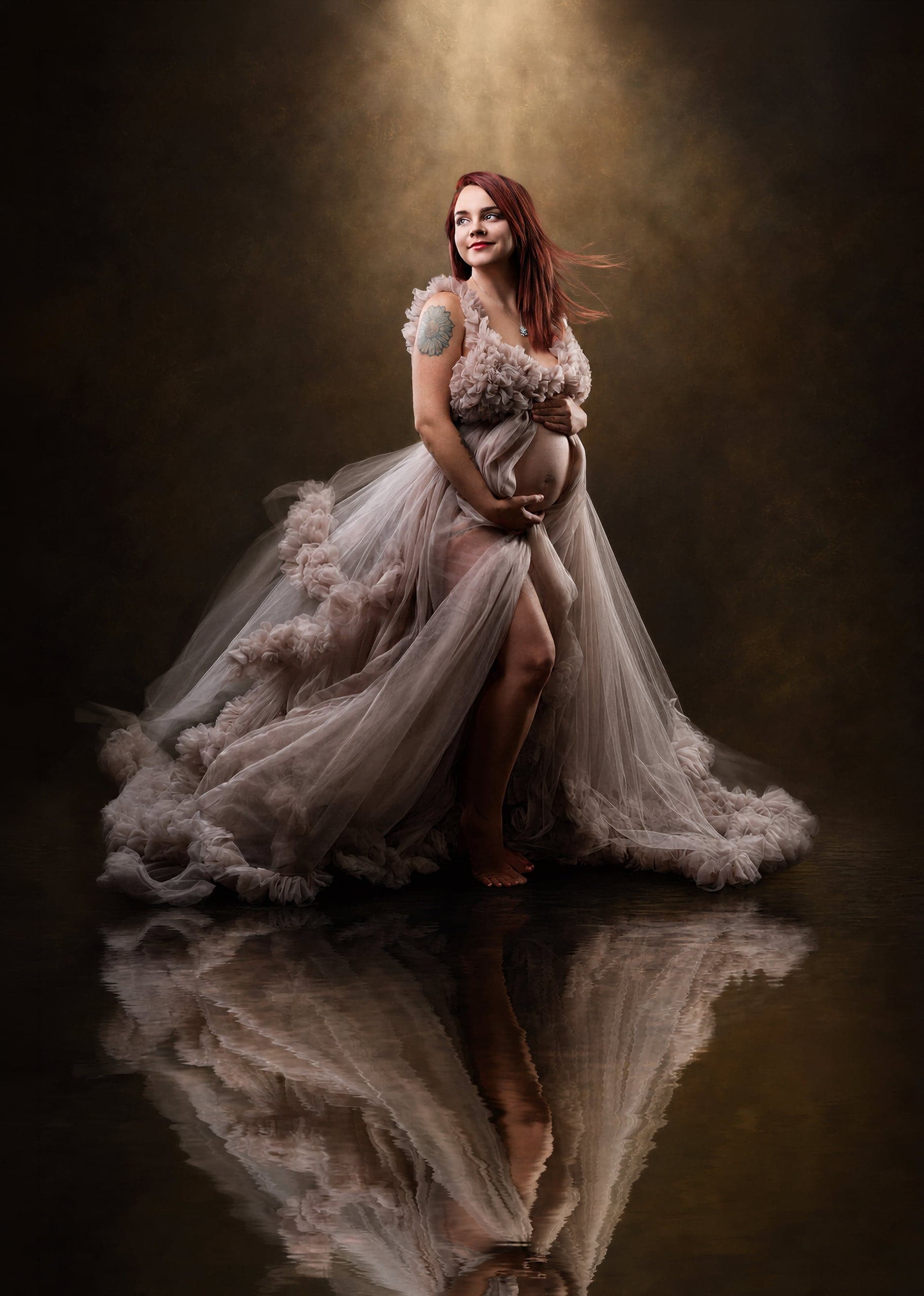 Maternity portrait in a taupe gown with a mirror reflection