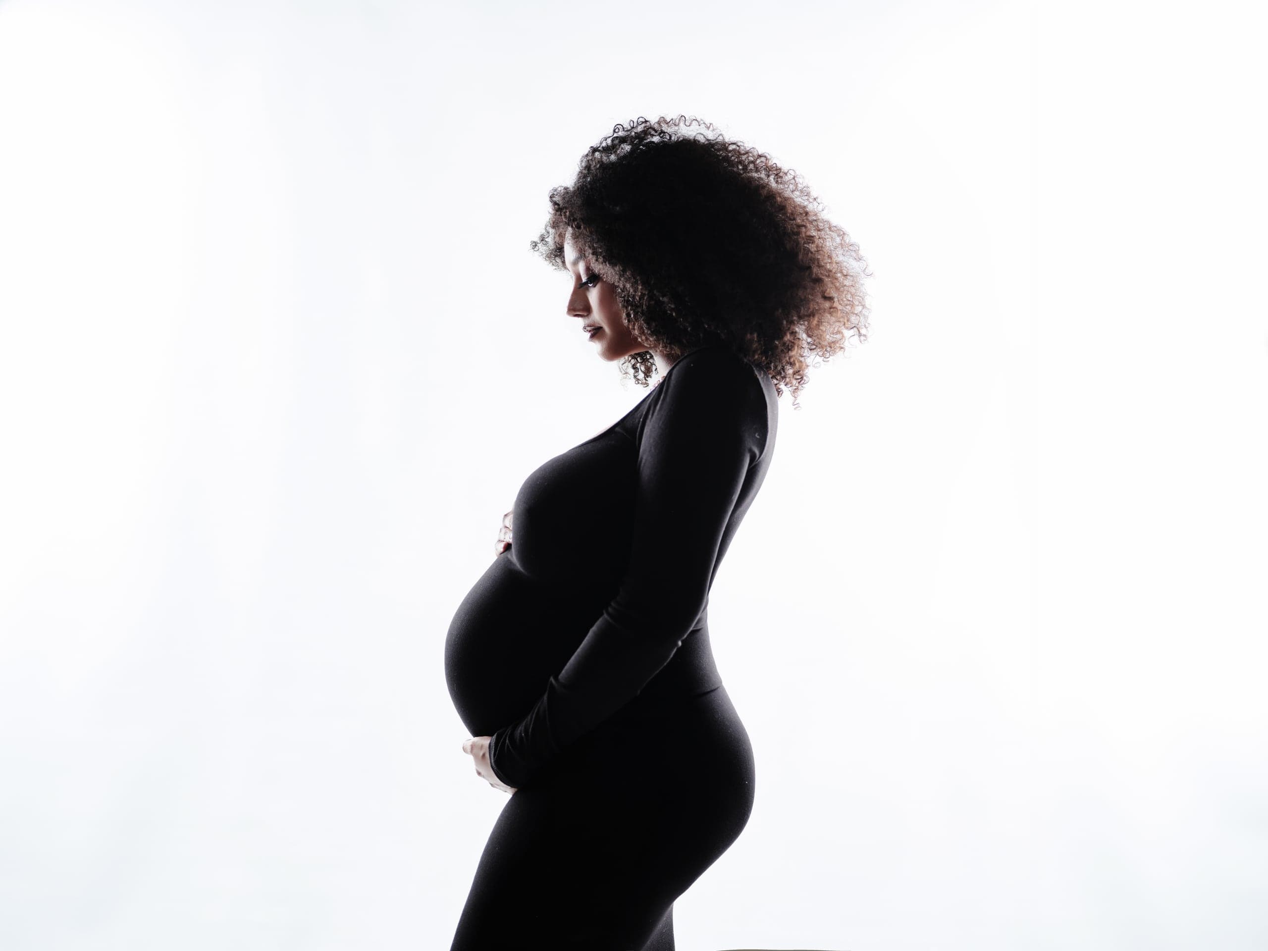 Backlit silhouette maternity portrait