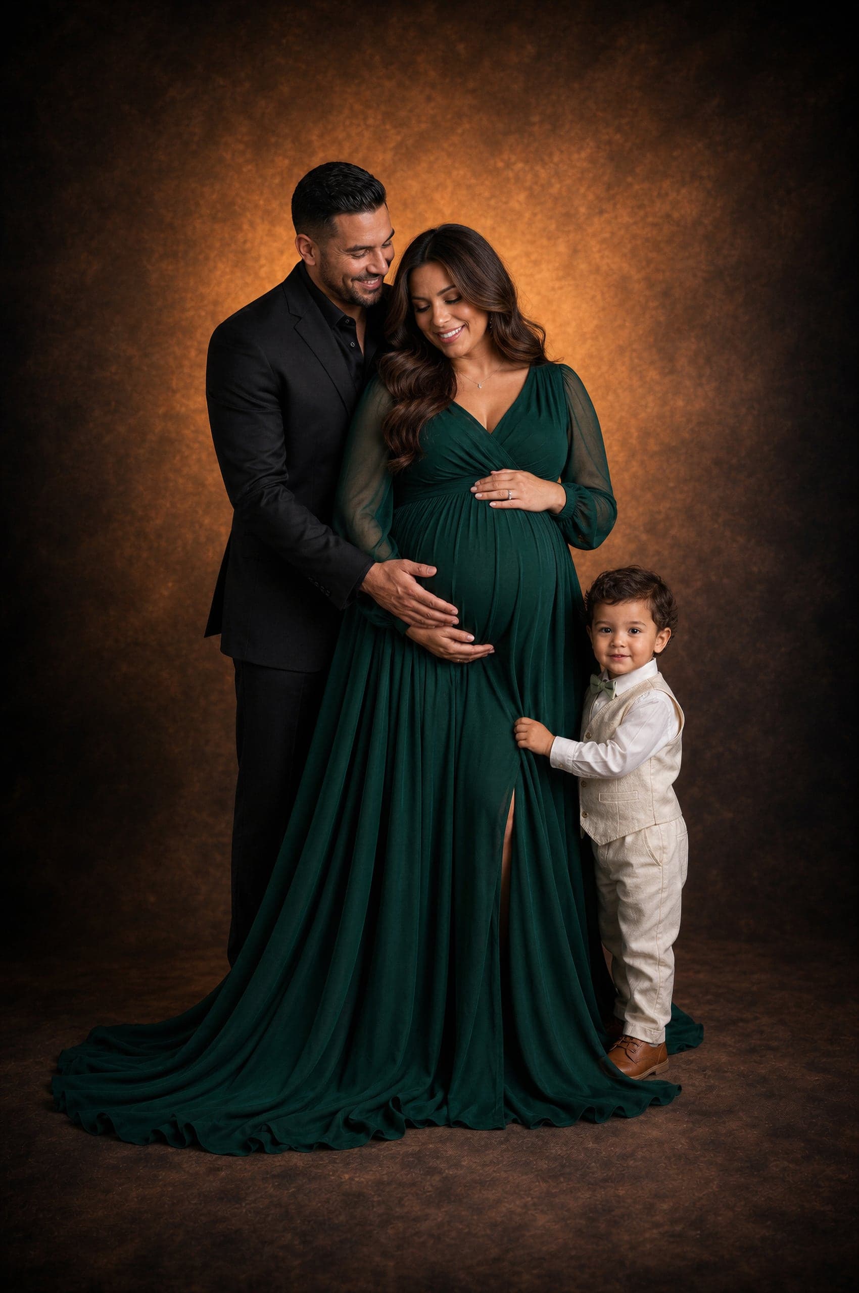 Maternity portrait with partner and toddler, mother in an emerald gown