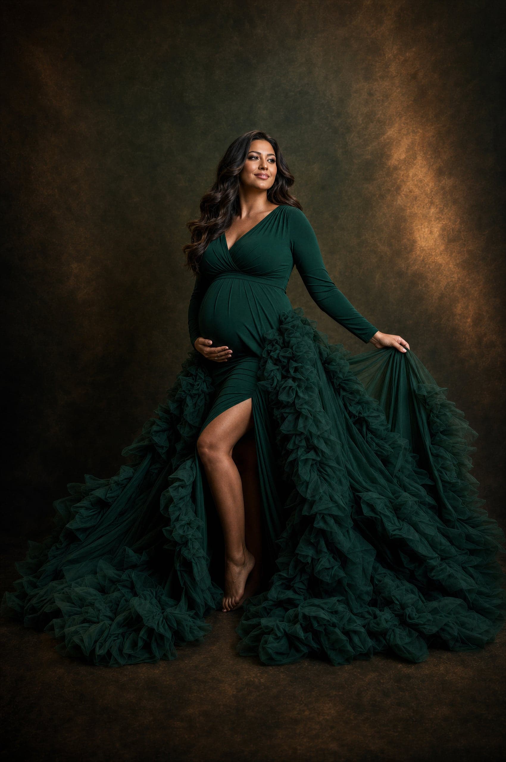 Maternity portrait in a dramatic emerald ruffled gown