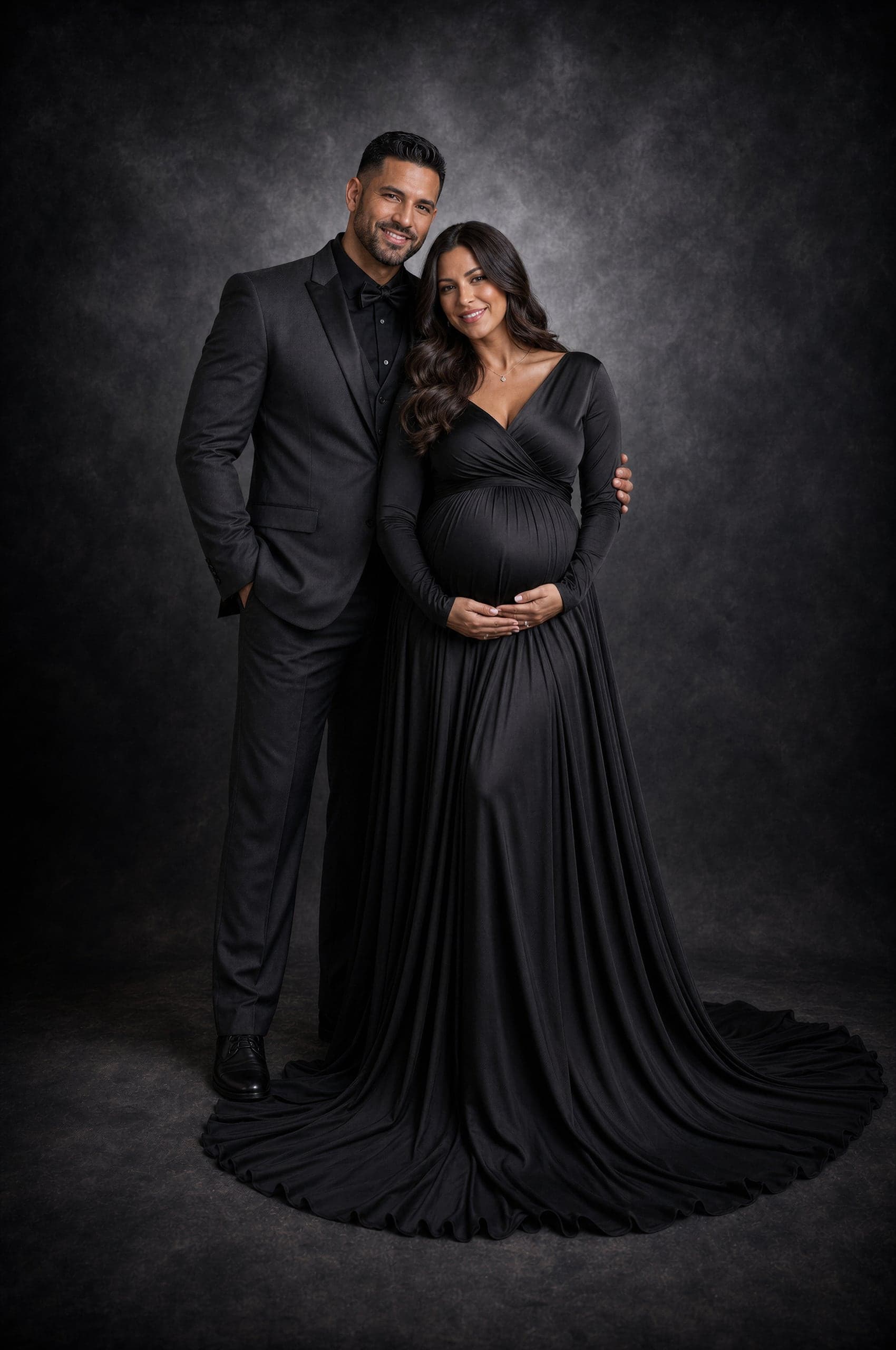 Expecting couple in an elegant black-tie studio portrait