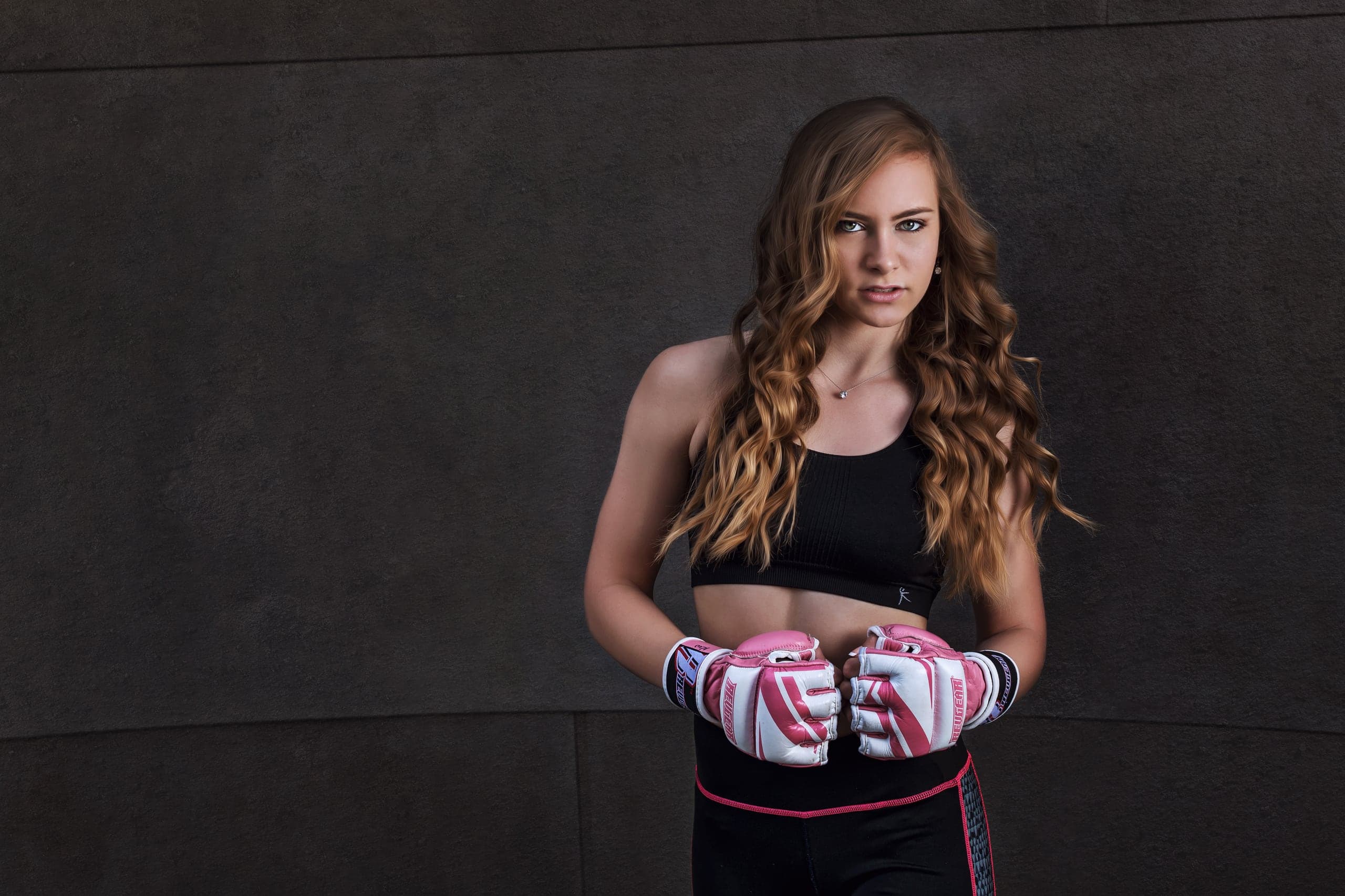 Senior portrait of a boxer with her gloves