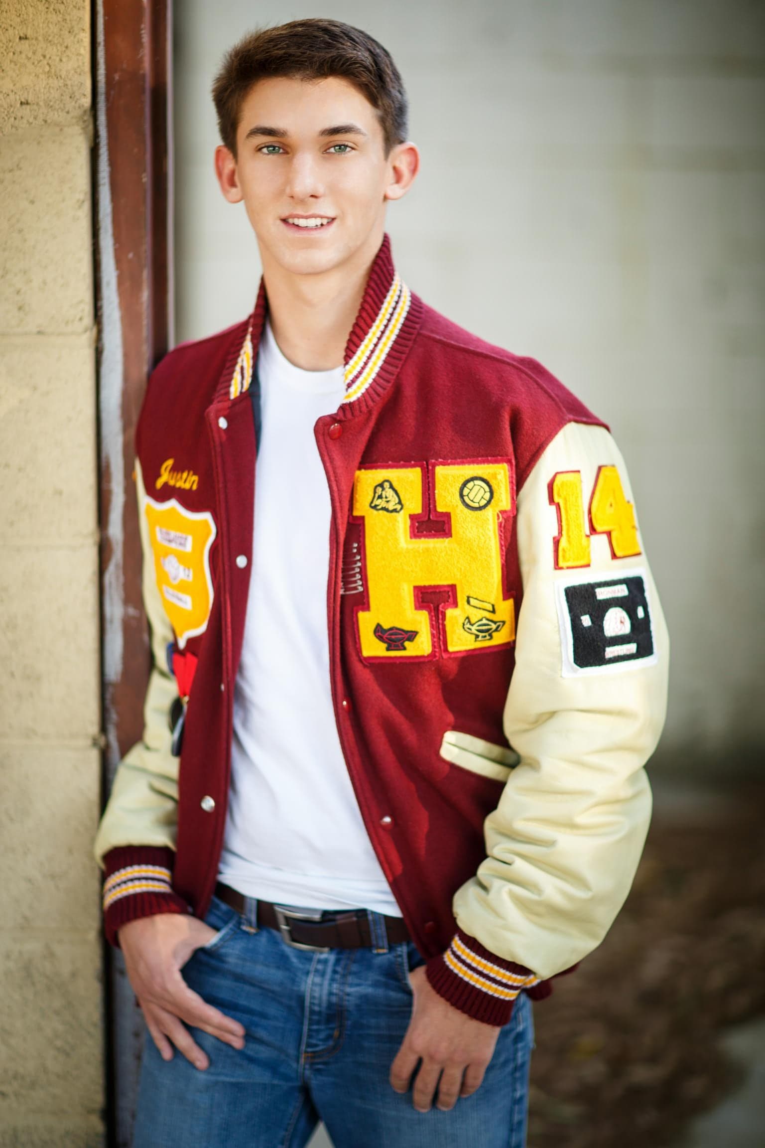 Senior portrait in a varsity letterman jacket