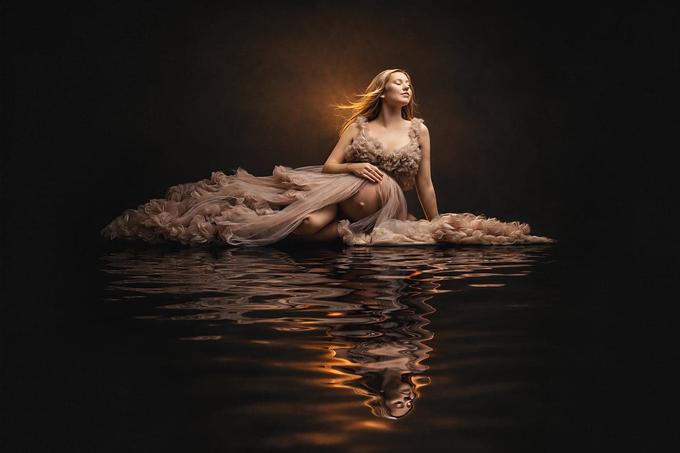 Maternity portrait adrift on still water