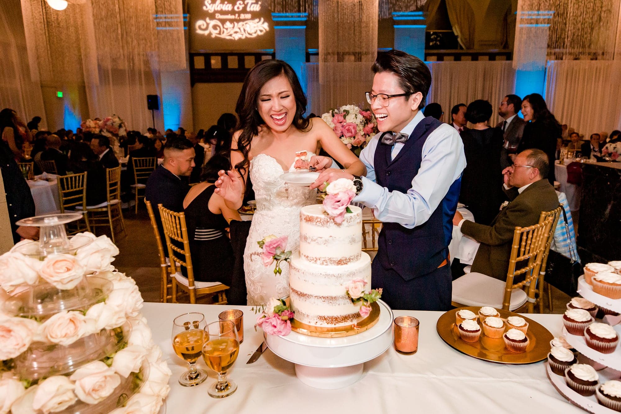 The newlyweds cutting their wedding cake
