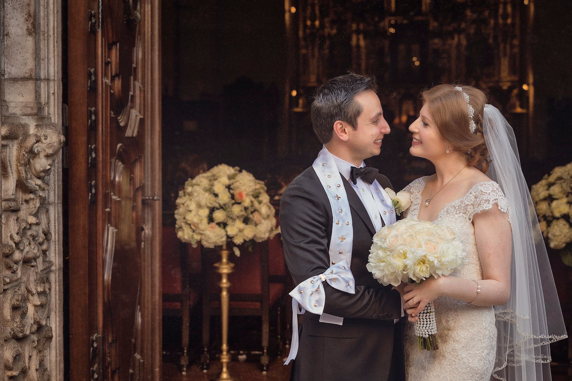 Wedding couple together inside the ornate church