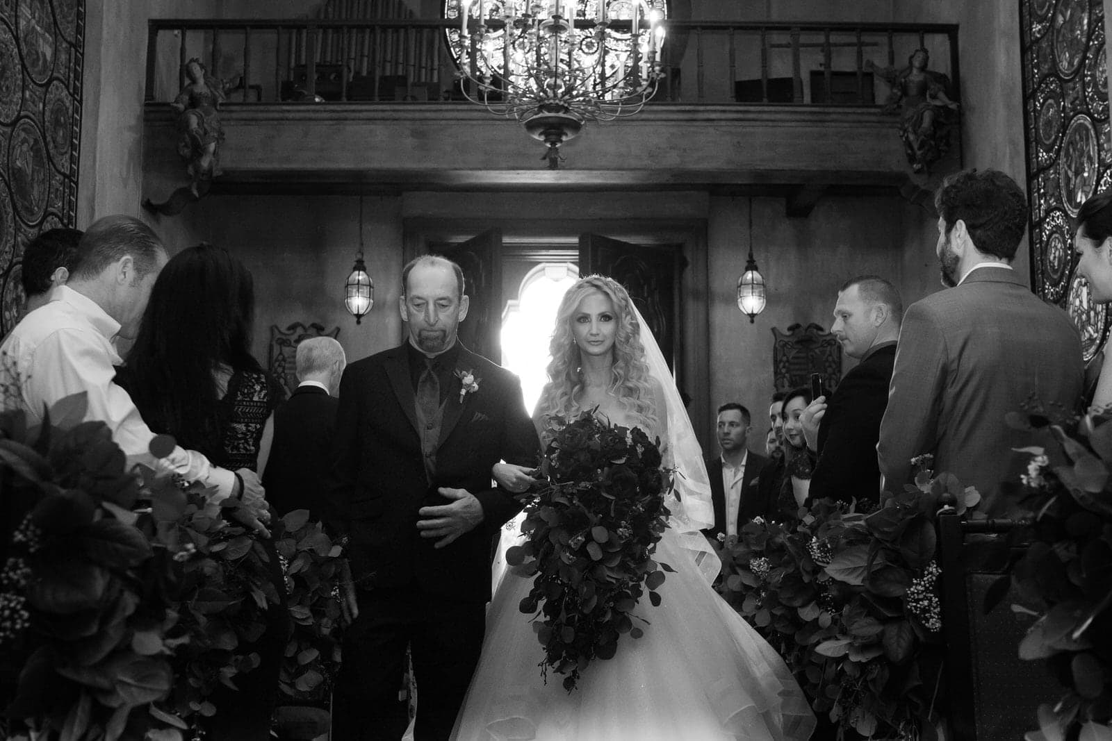 Bride and groom together beneath carved stone details