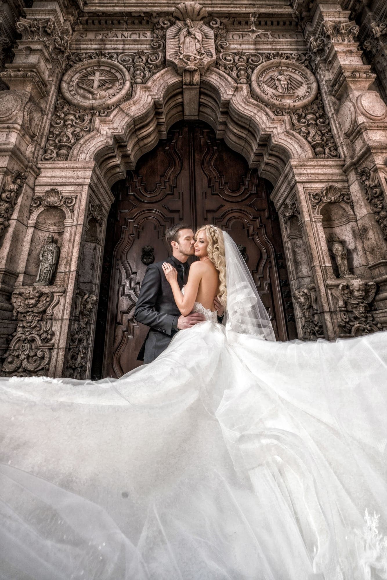 The Severen couple beneath the carved Mission Inn entrance