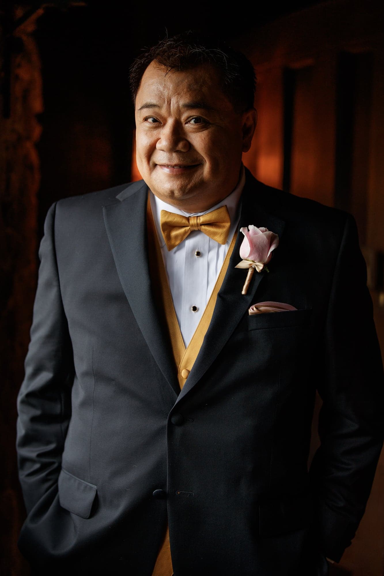 Groom in black and gold wedding attire
