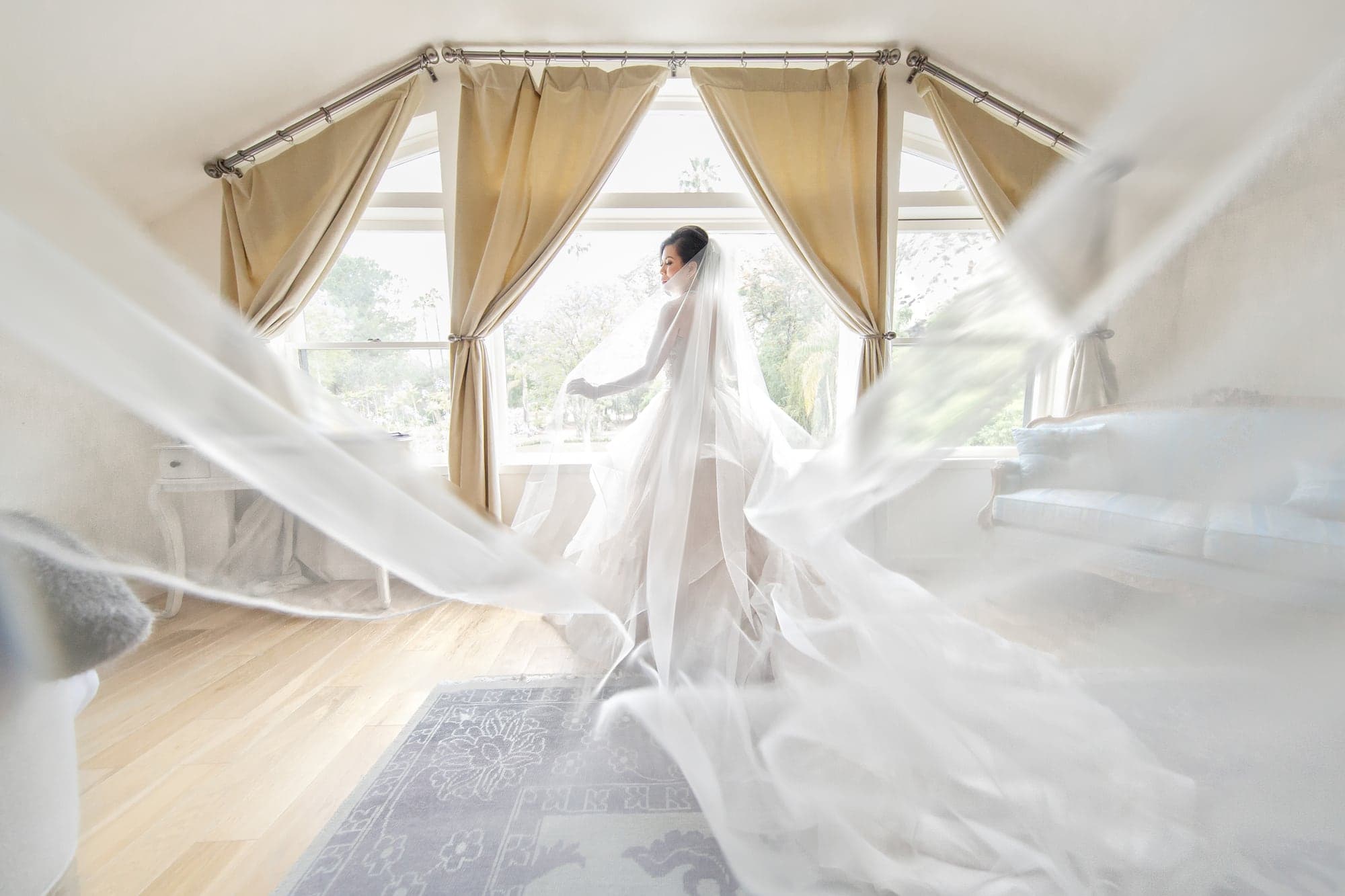 Bride framed by the mansion suite windows