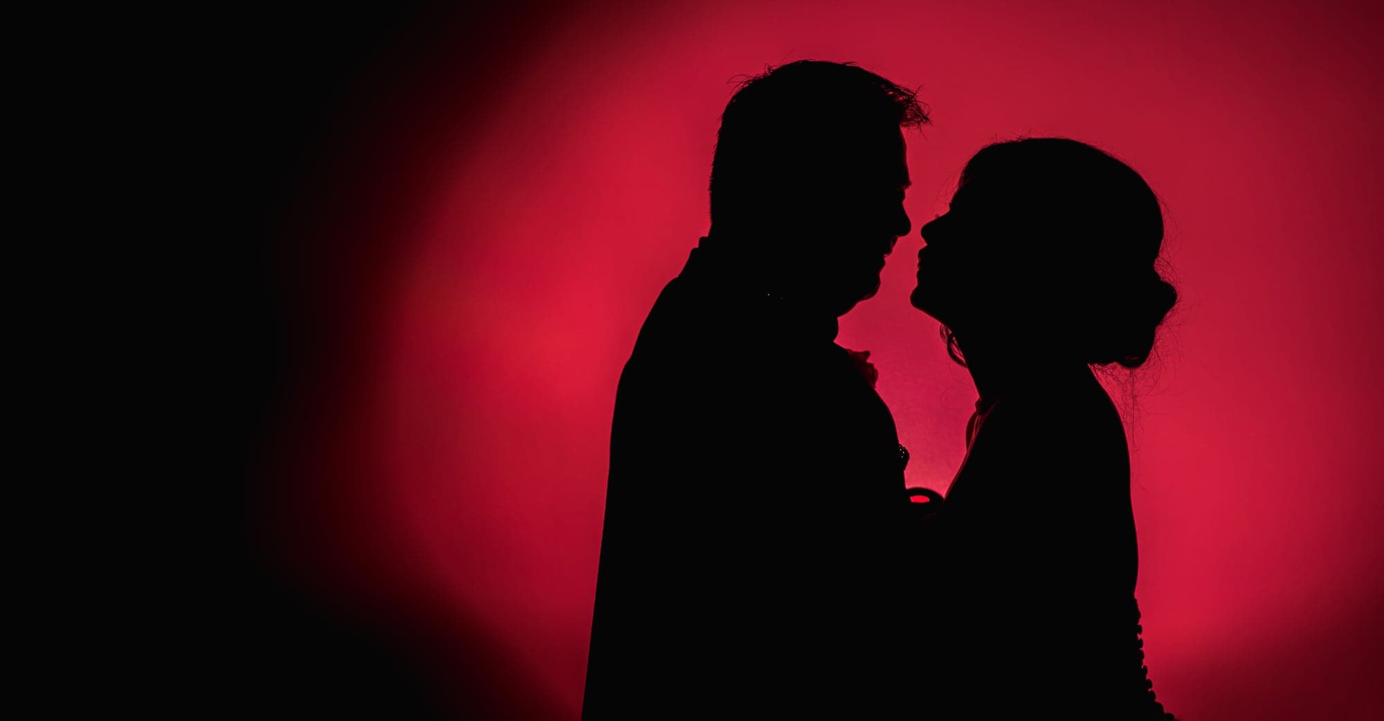 Red silhouette portrait of the newlyweds