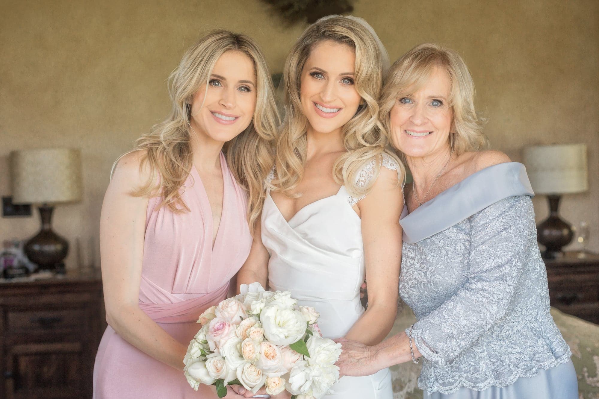 Bride with family members and blush flowers