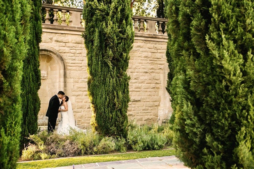 The carved stone staircase and formal terraces of Greystone Mansion & Gardens in Beverly Hills at golden hour.