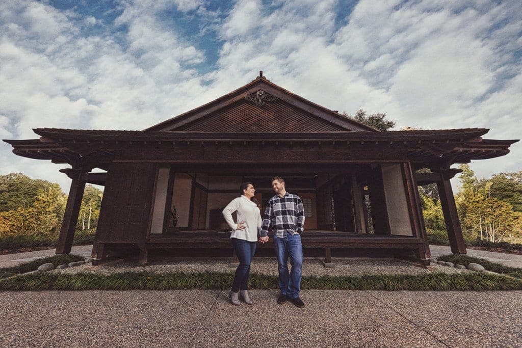 A couple posing among the roses and manicured hedges of the Rose Garden at the Huntington in San Marino.