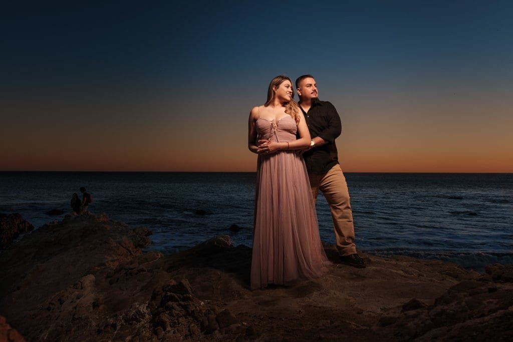 The rocky north end of Leo Carrillo State Beach in Malibu at golden hour, with sea caves and wave-carved rock formations along the shoreline.