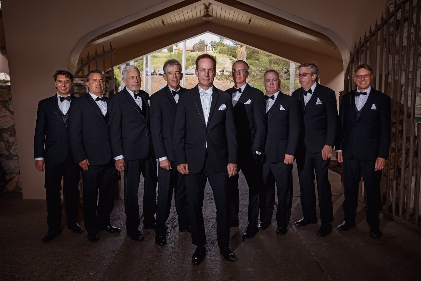 The wedding party under the clubhouse archway at Los Verdes Golf Course