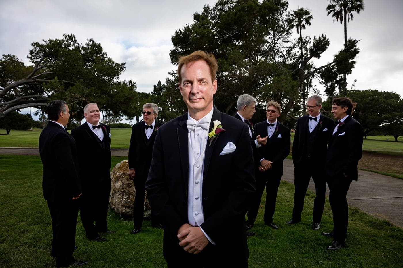 Groom with his groomsmen beneath the palms at Los Verdes Golf Course