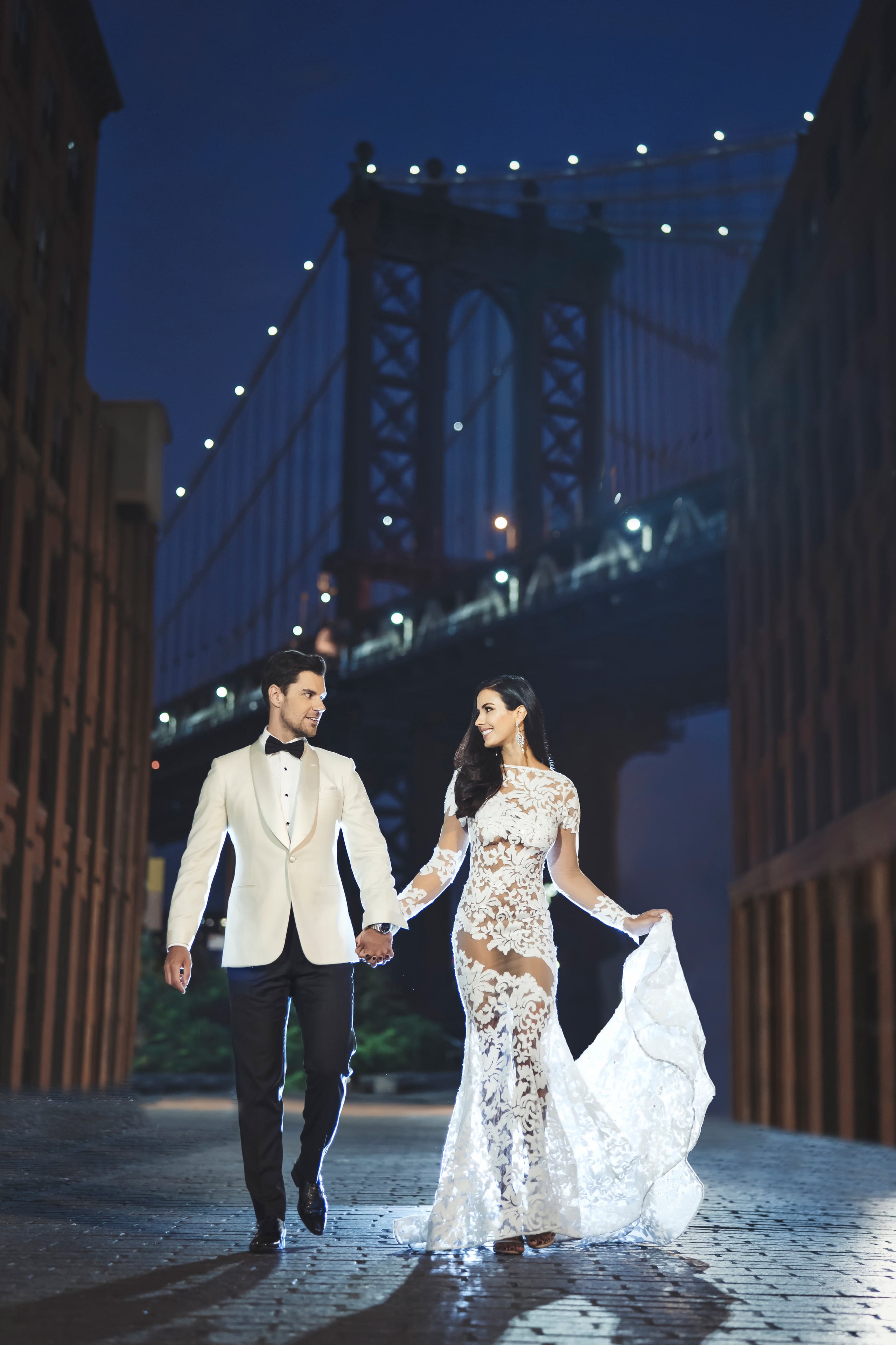 Newlyweds walking beneath the Manhattan Bridge in Dumbo