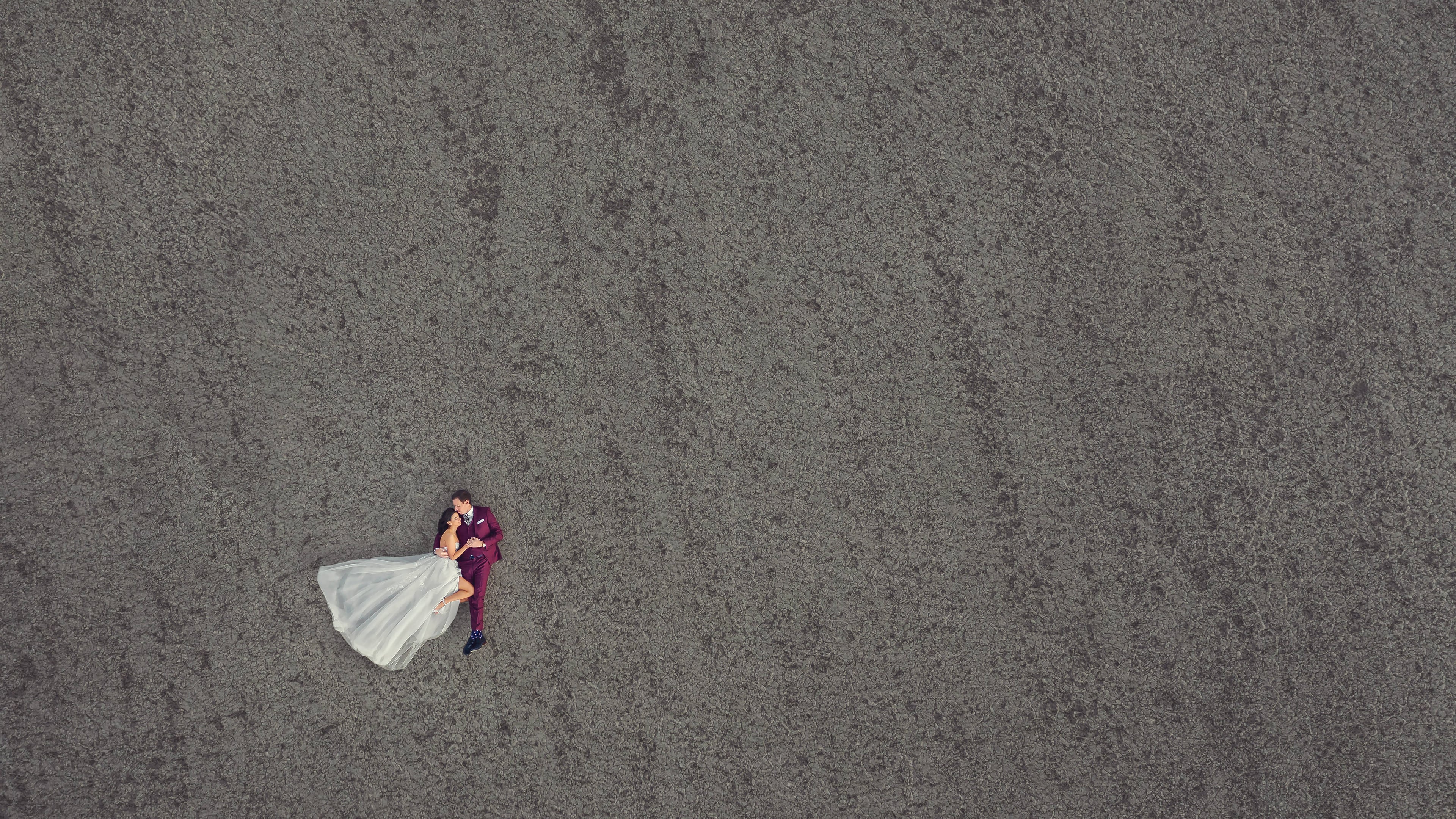 Aerial portrait of a couple alone in a wide architectural space
