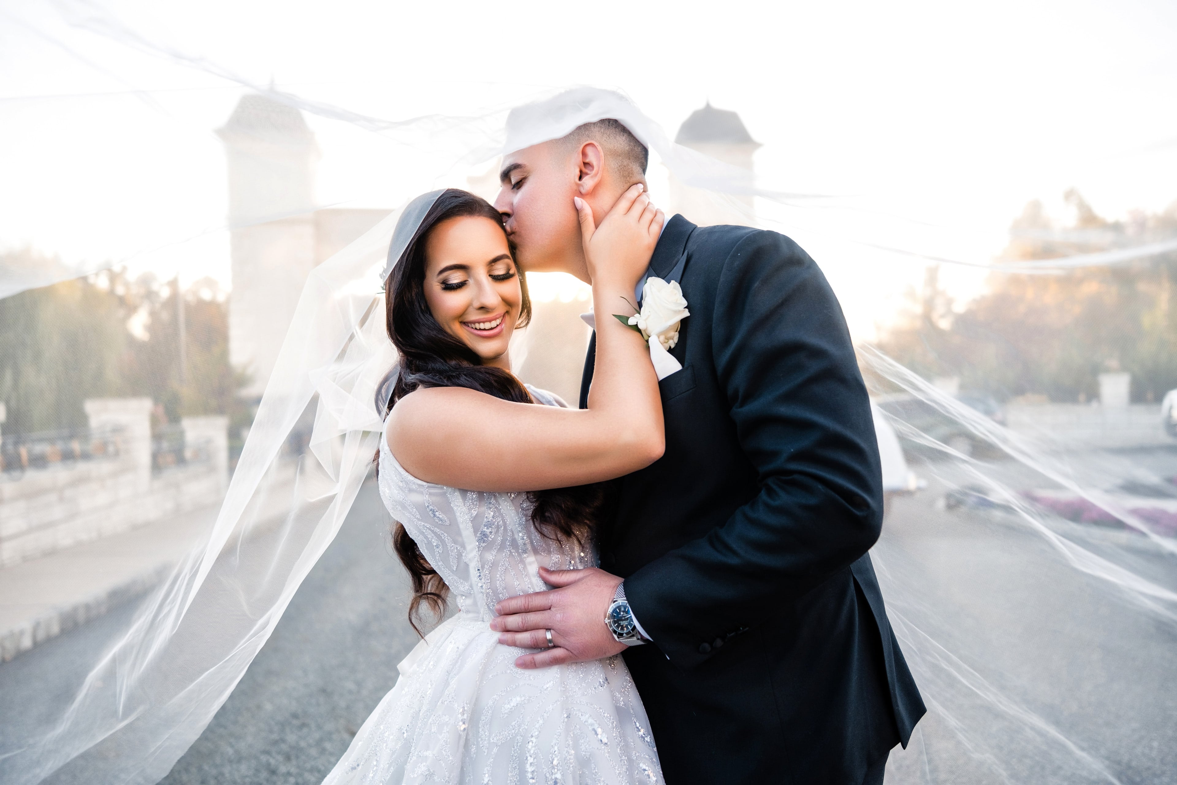 Bride and groom embracing outside Legacy Castle