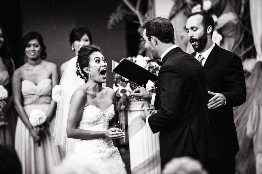 Bride reacting with joy during an emotional wedding ceremony