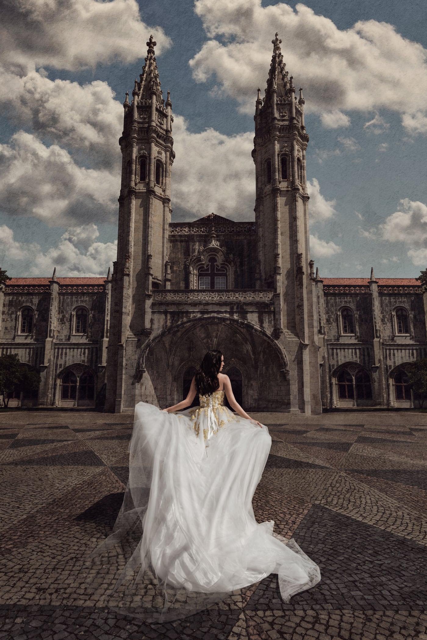 A couple embracing before ornate stone architecture in Portugal