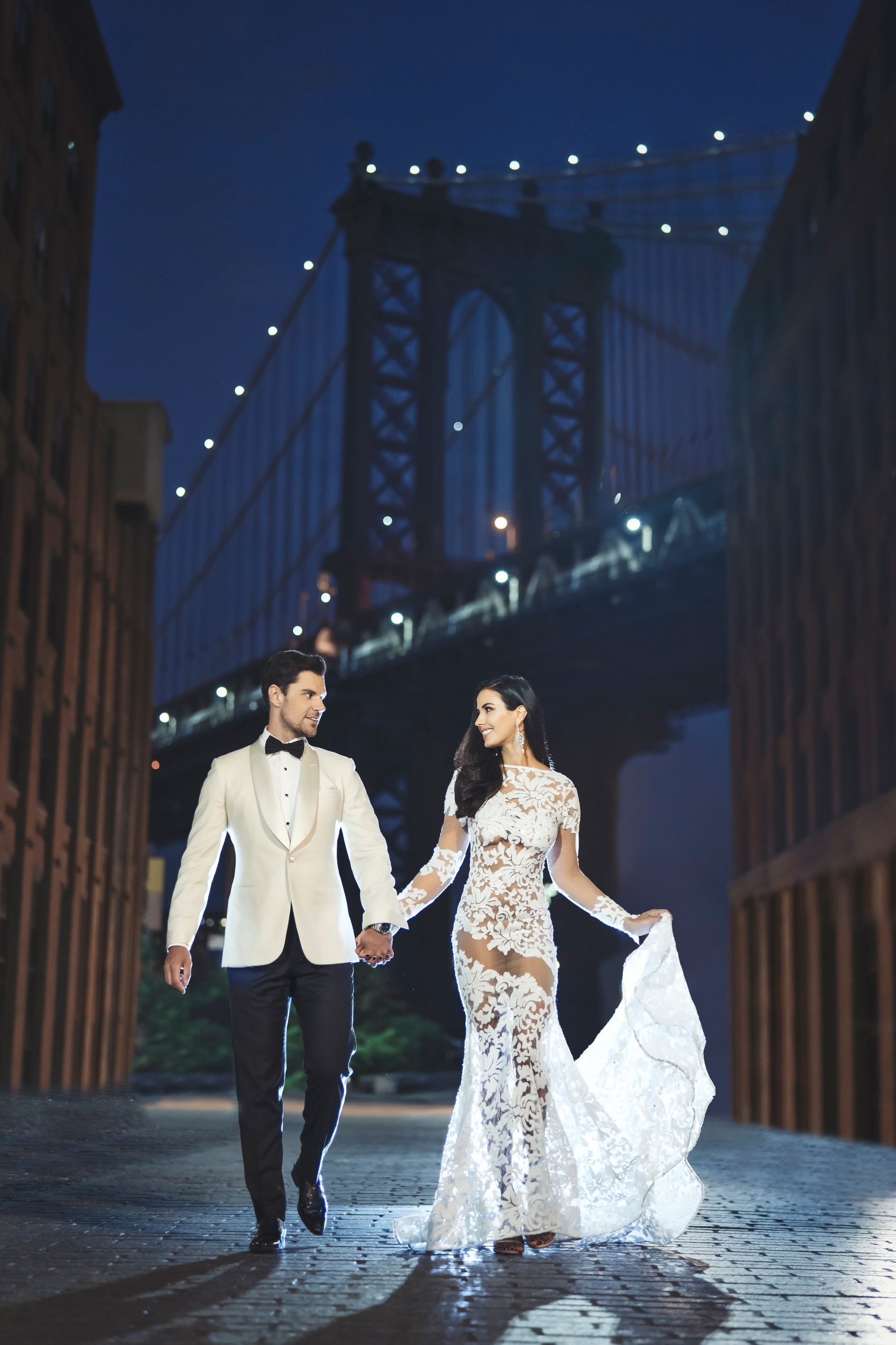 Newlyweds walking beneath the Manhattan Bridge in Dumbo