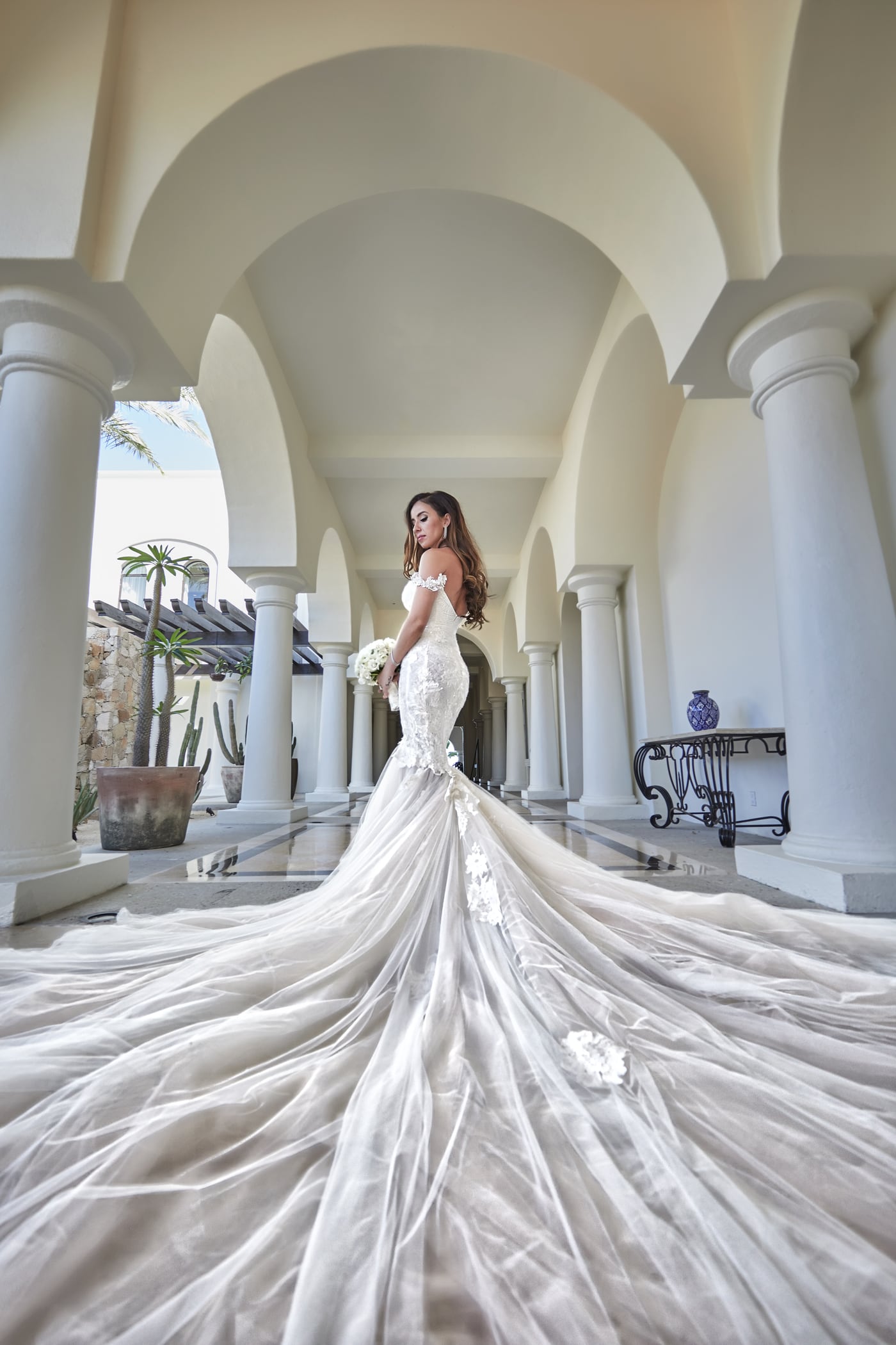 A bride beneath the sunlit arches of a Los Cabos resort
