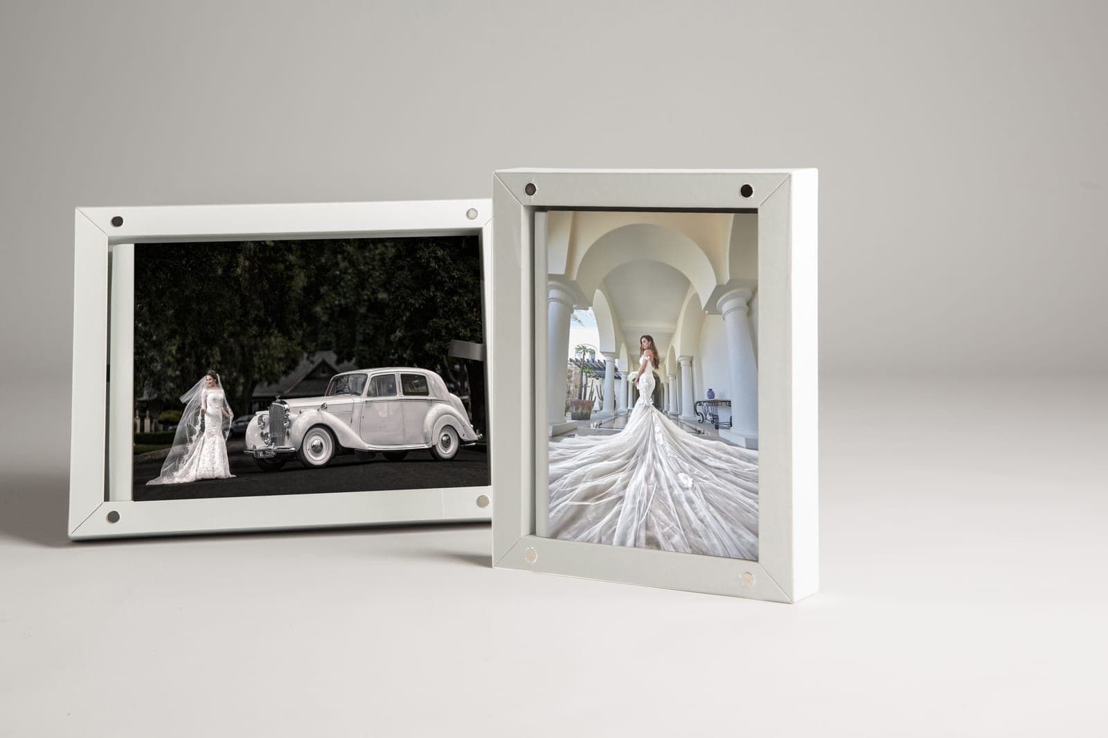 Two acrylic block prints standing on a pale surface, one horizontal and one vertical, each held by corner standoffs