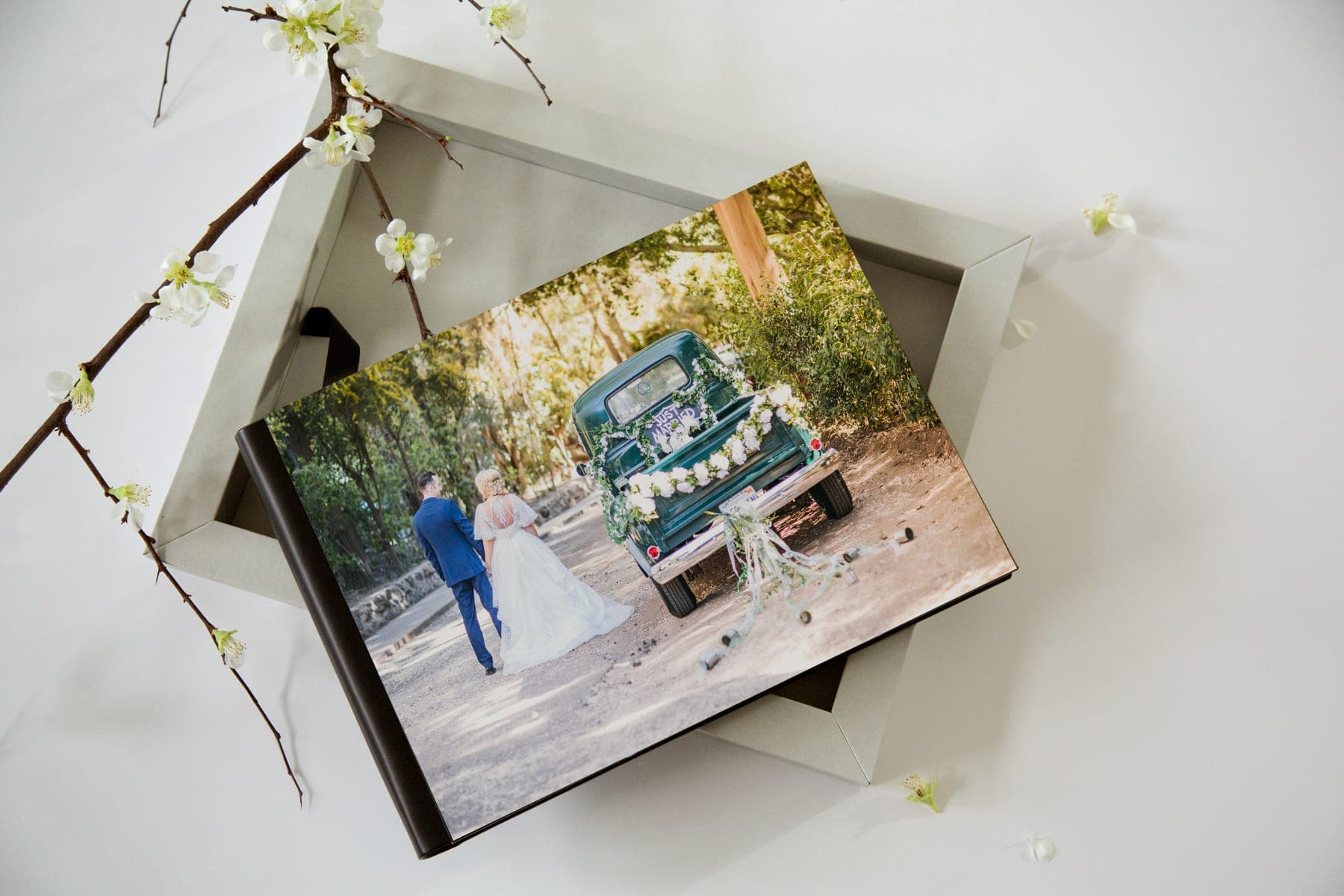 A Fine Art Album with a photographic cover resting on its open linen presentation box