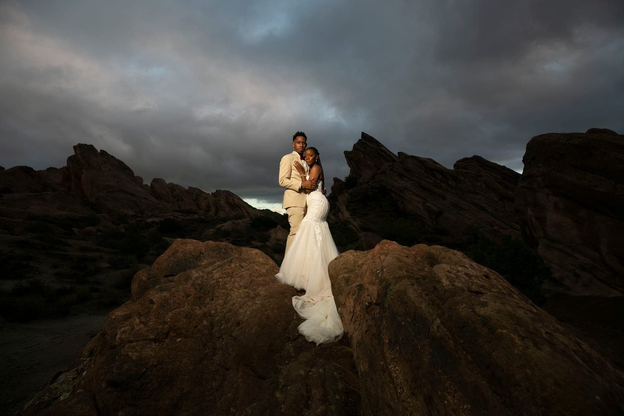 a bride and groom on the rock formations at Vasquez Rocks, straight out of camera