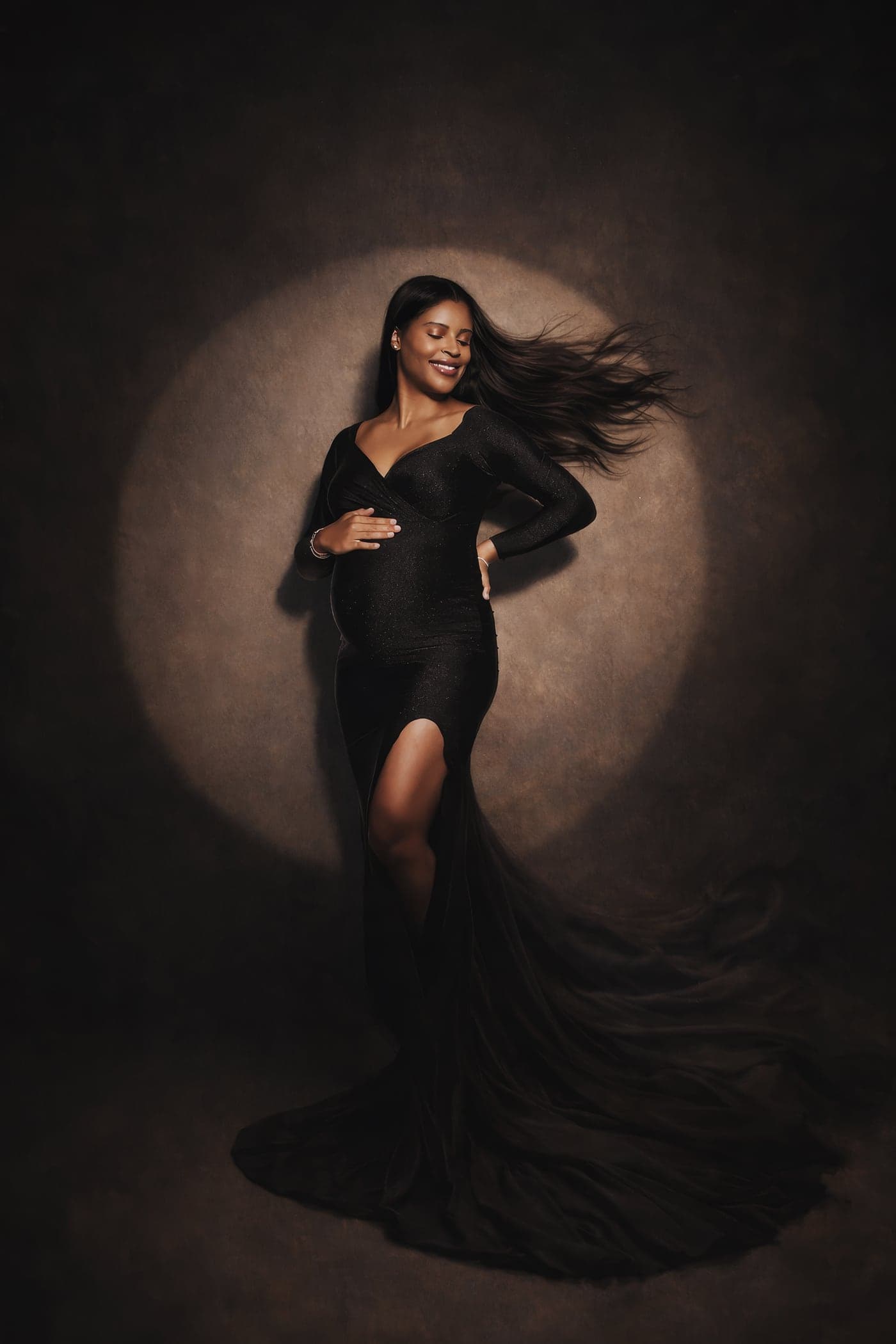 Dramatic fine-art studio maternity portrait