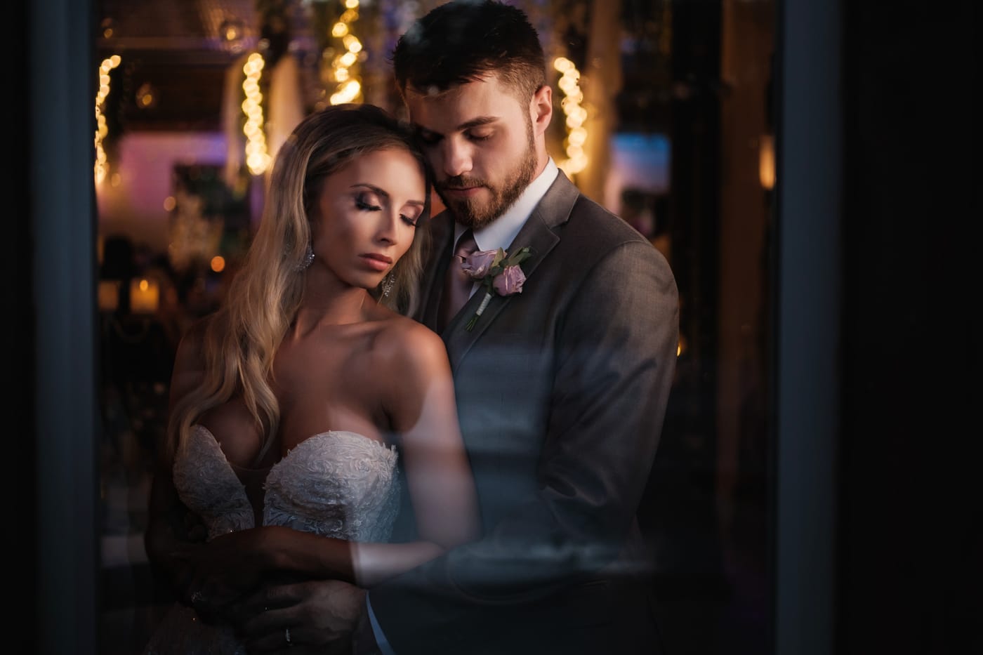 A bride and groom in warm reception light at Fiddle Dee Farms
