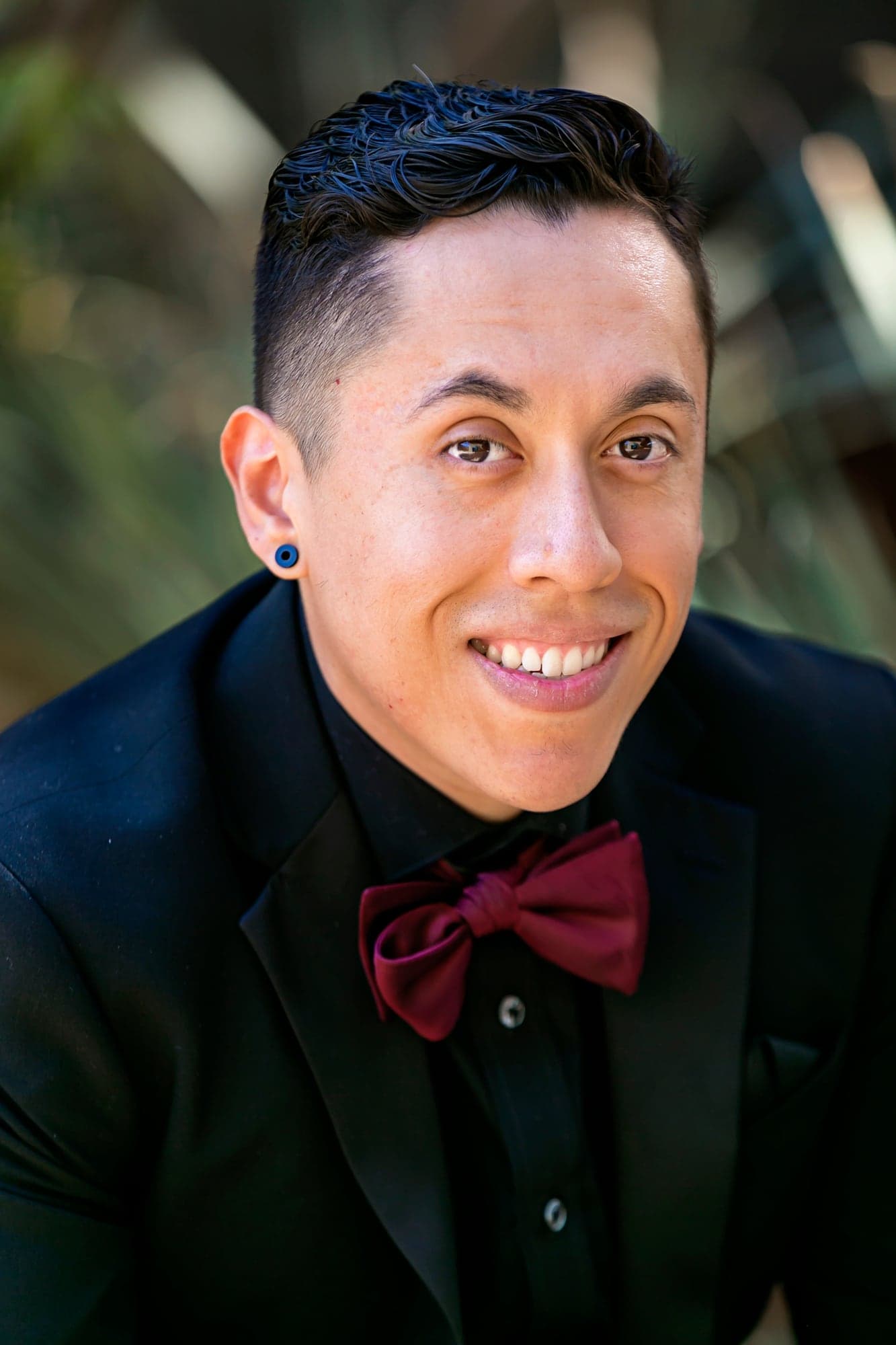 Alejandro in his black suit and burgundy bow tie