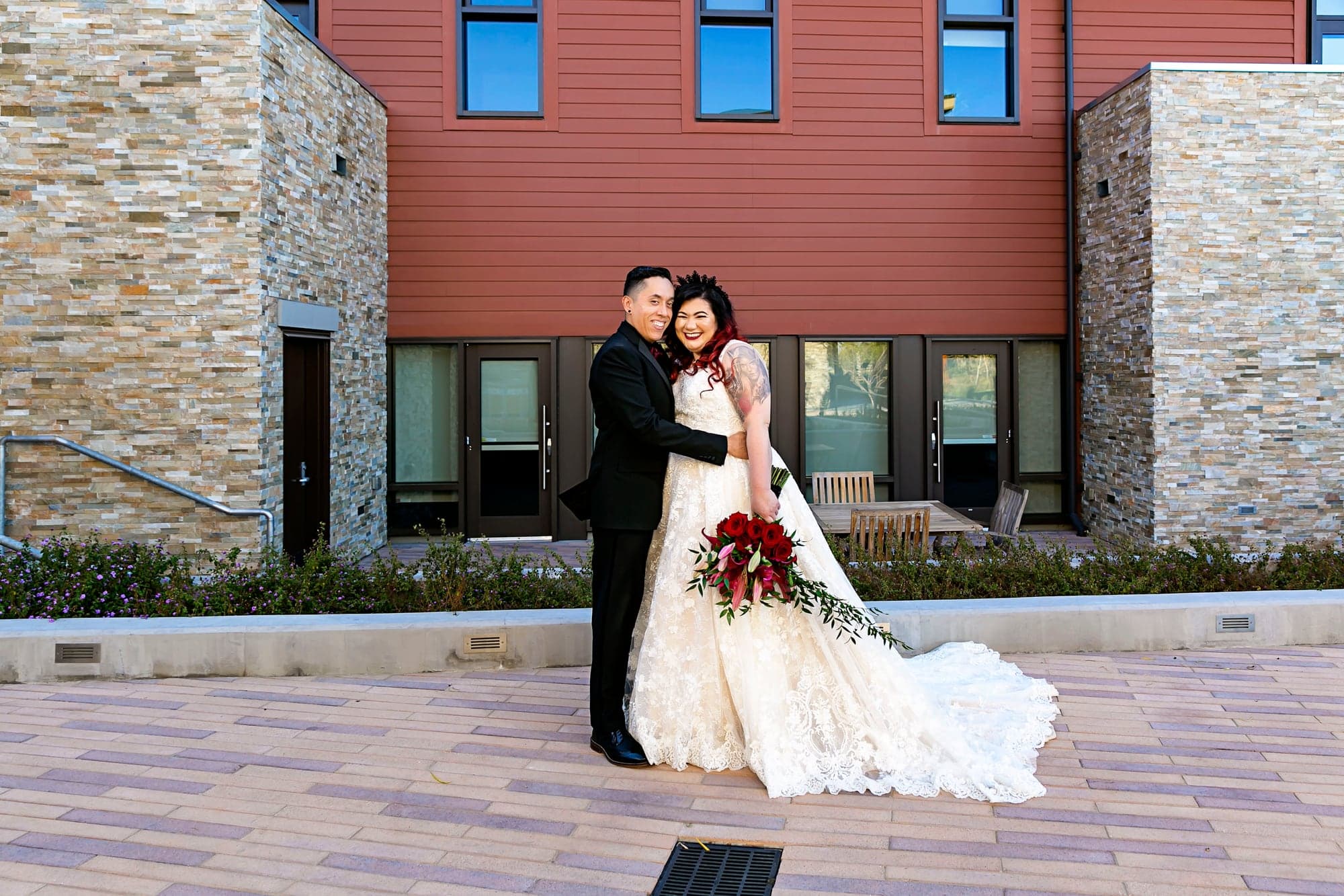 Melissa and Alejandro posing outside the venue
