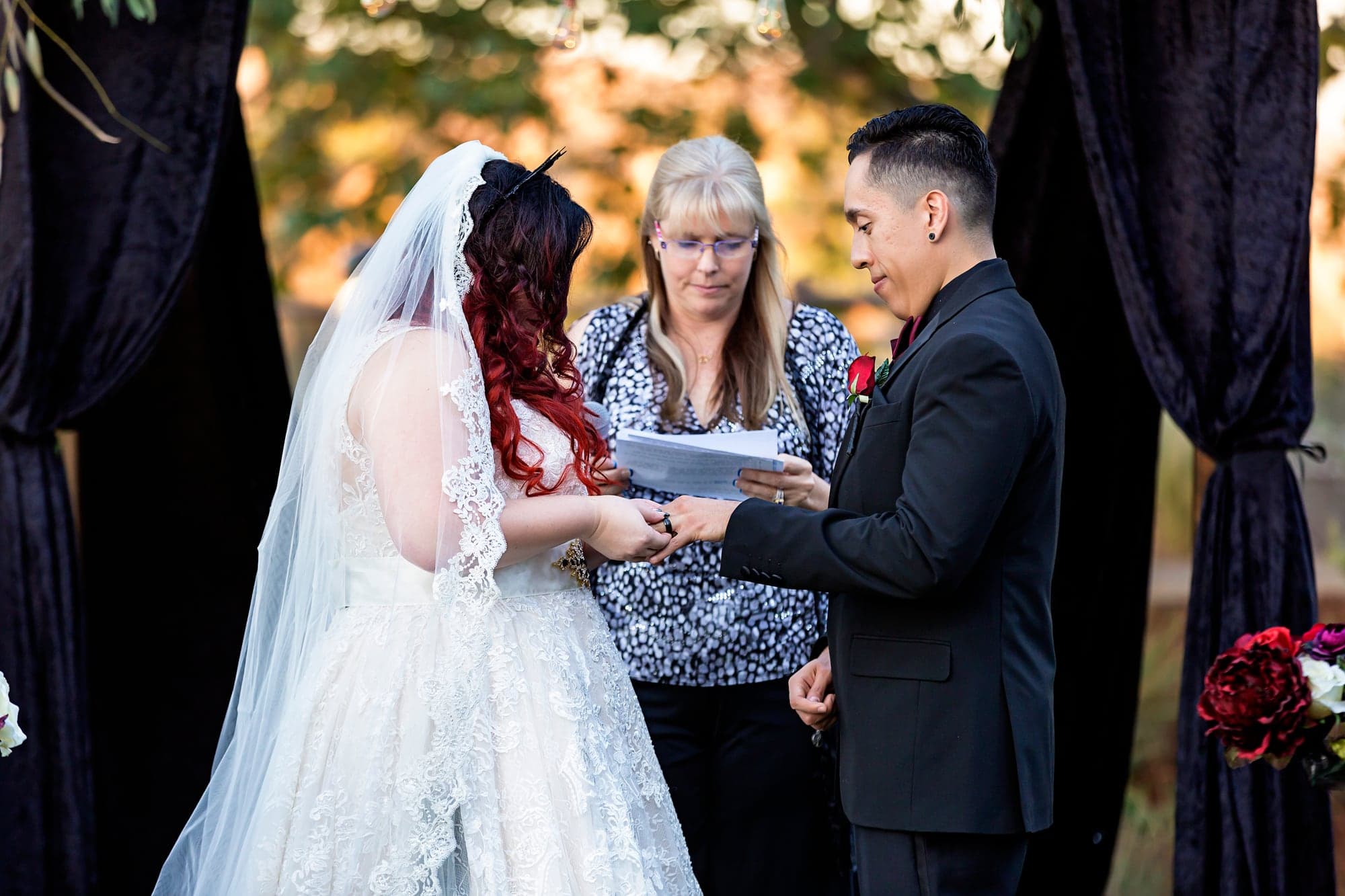 Melissa and Alejandro exchanging vows outdoors