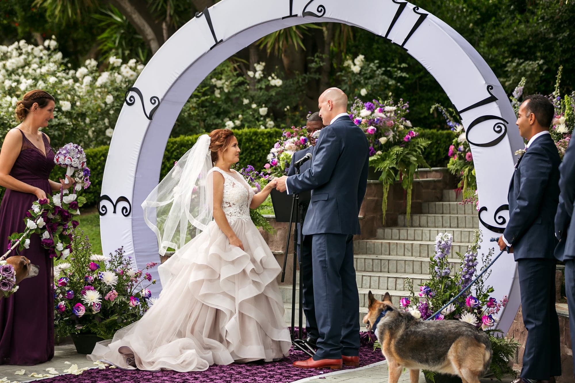Wedding couple exchanging rings during their garden ceremony