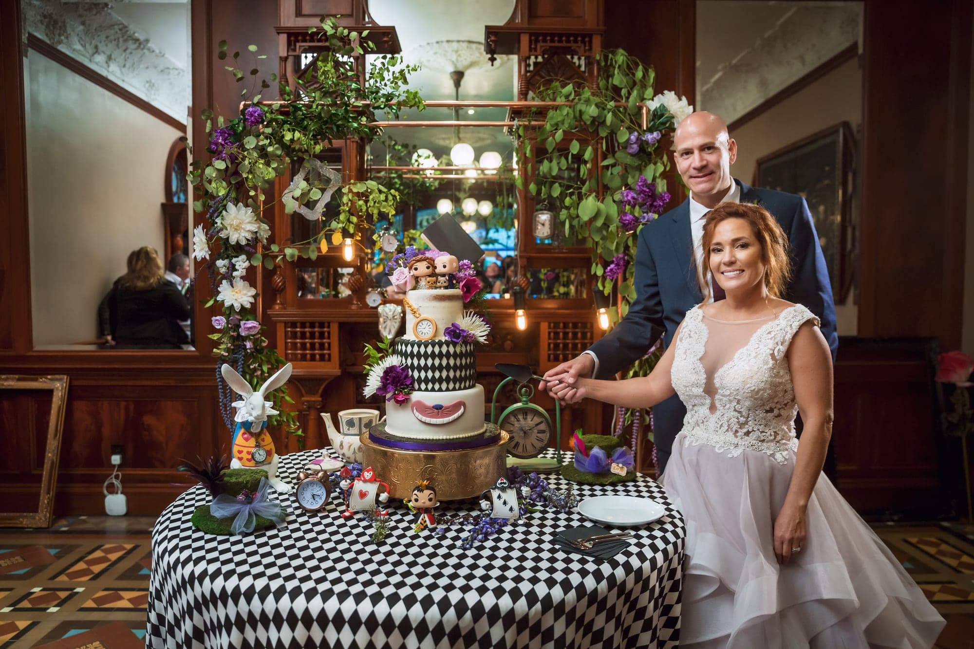 Bride beside the whimsical wedding cake display