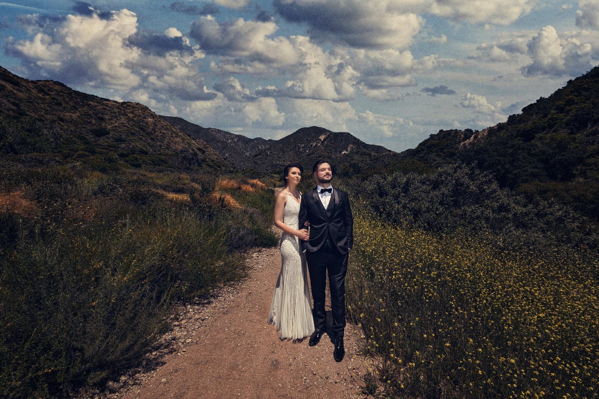 Tamara and Kevin standing together in the mountain landscape