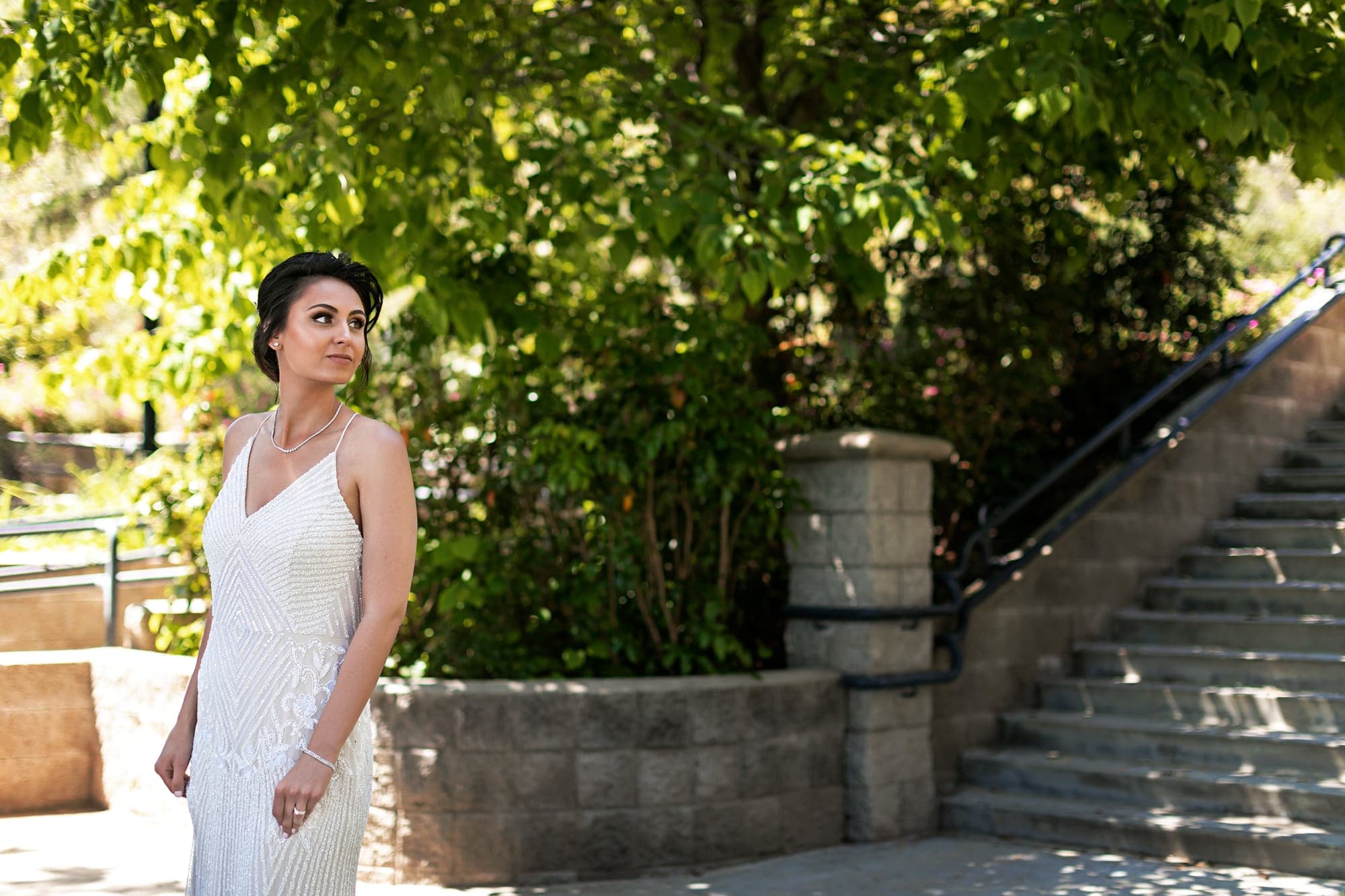 Tamara posing for a bridal portrait beside stone steps
