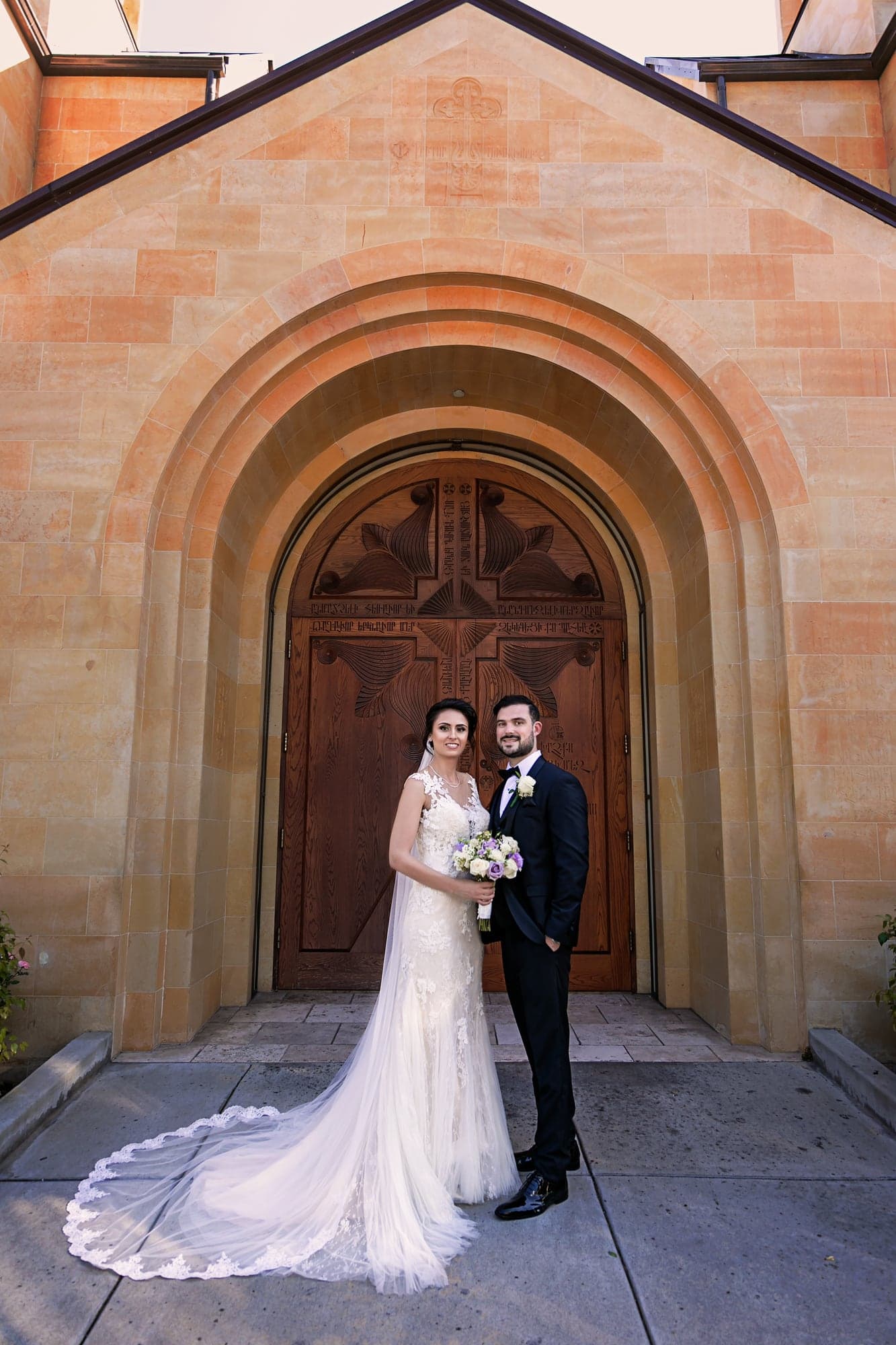 Tamara and Kevin standing outside St. Gregory Armenian Catholic Church