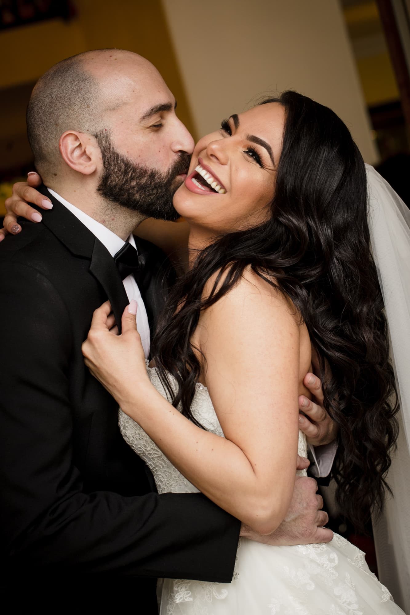 Hrug kissing Margaret's cheek as she laughs, her dark hair over her shoulder