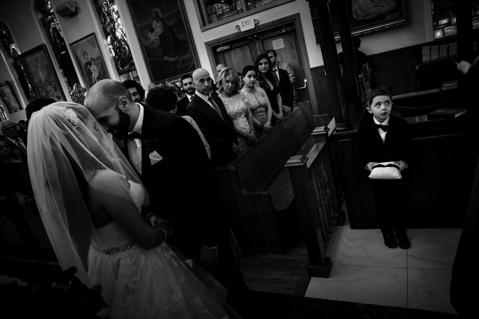 Black and white photograph of Margaret and Hrug's first kiss during their Armenian church ceremony