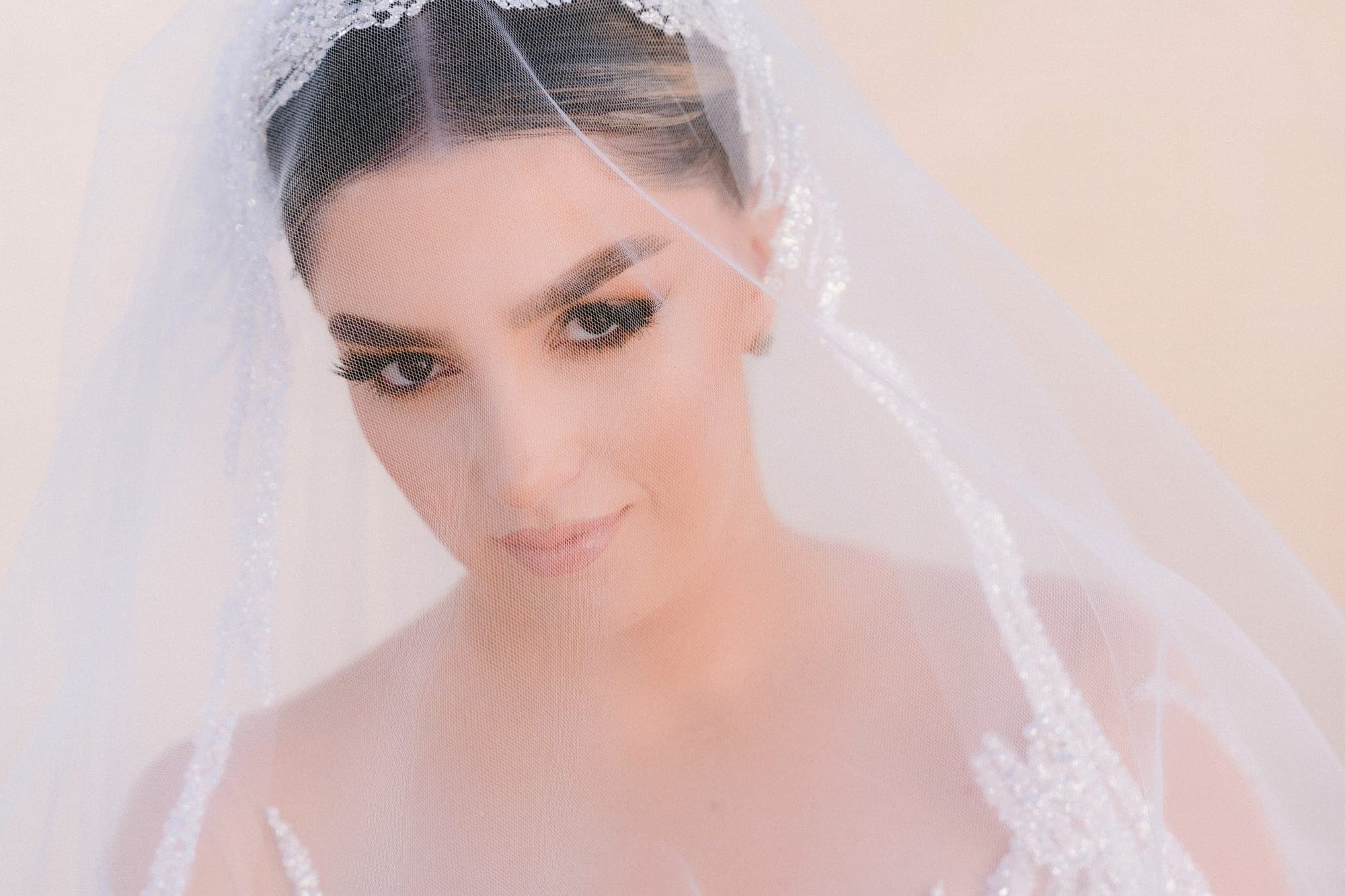 Close bridal portrait through the layers of the veil