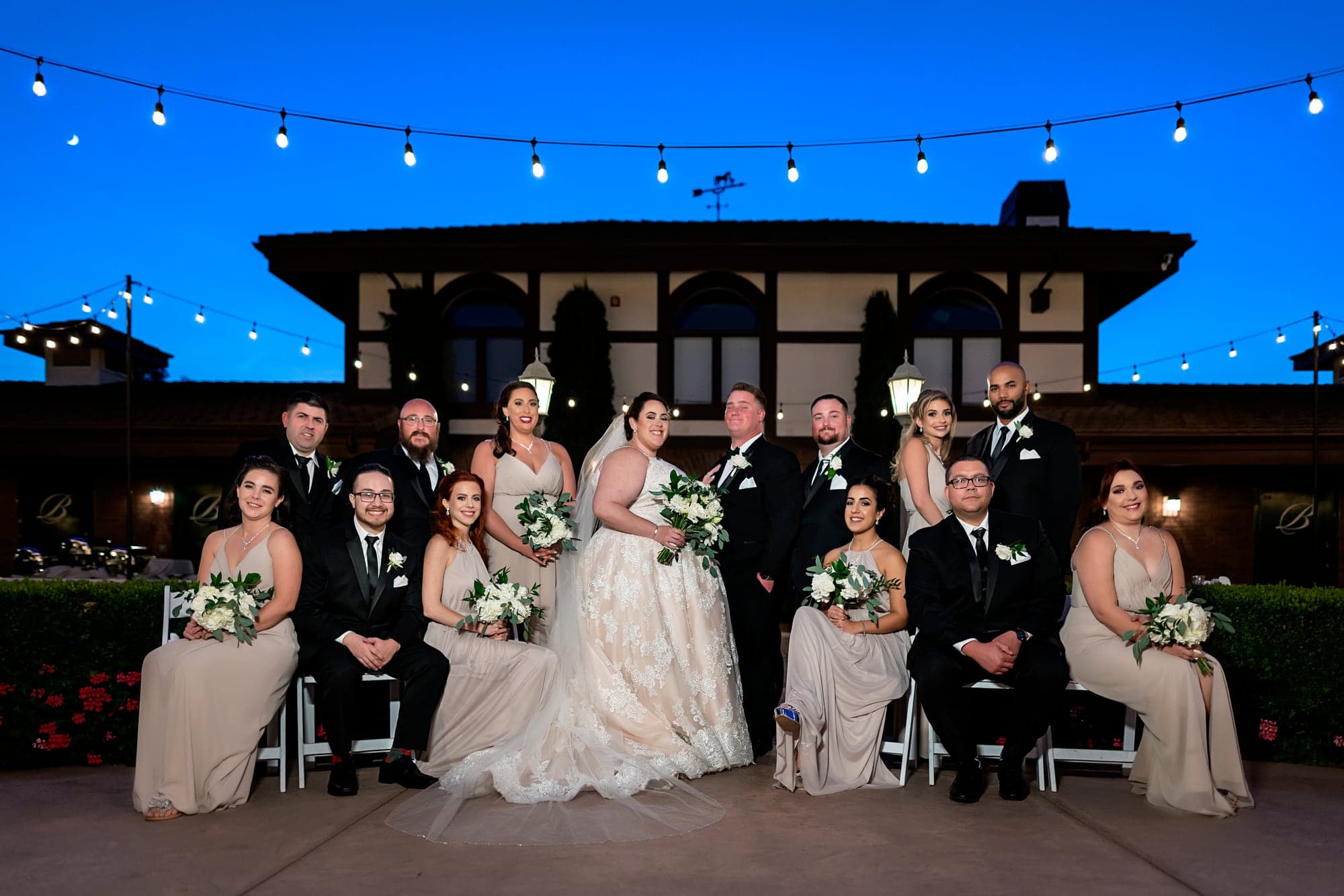 The newlyweds beneath evening string lights