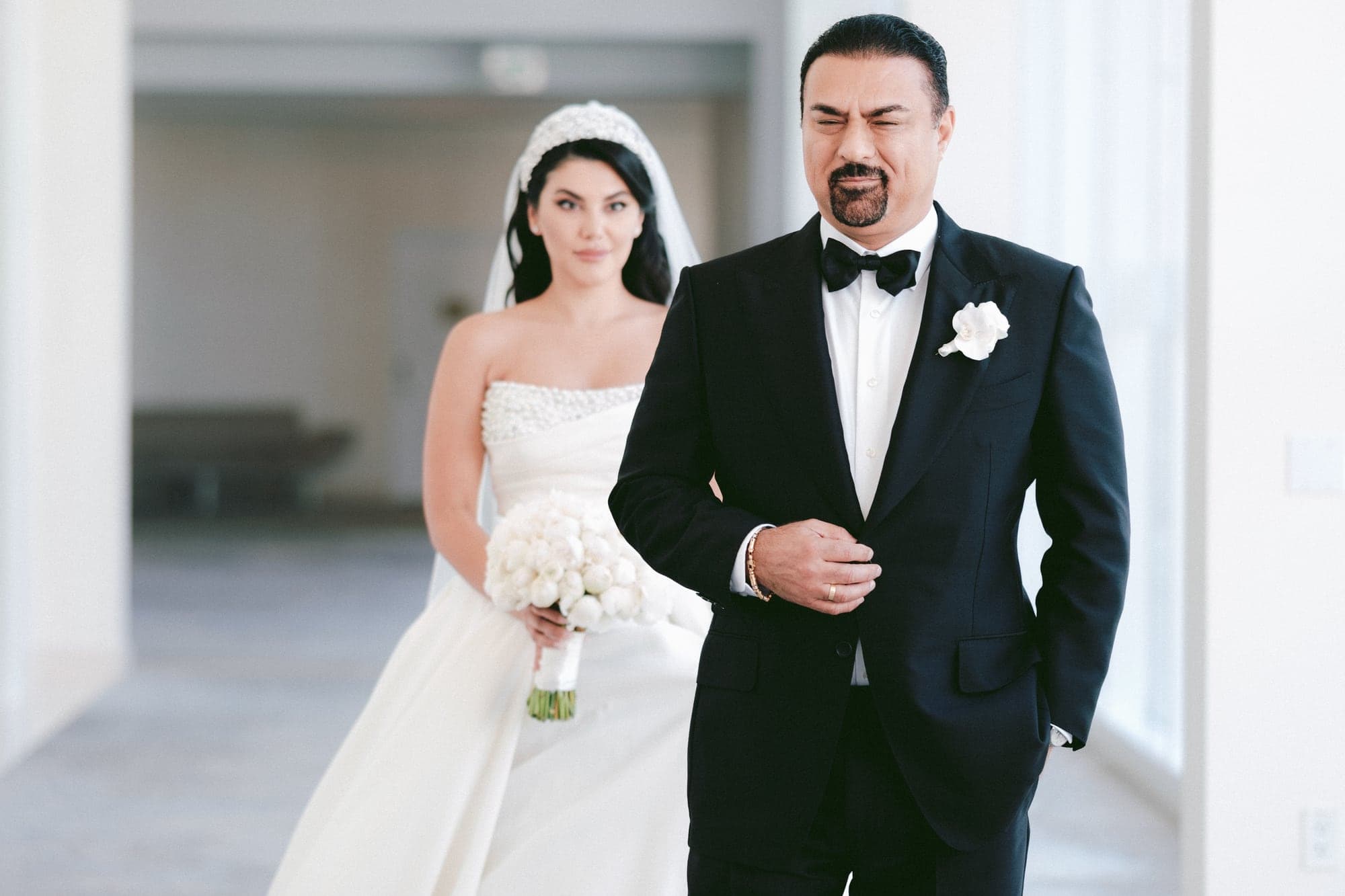 Ghazal and her groom standing together in the bright modern interior of the Beverly Hilton